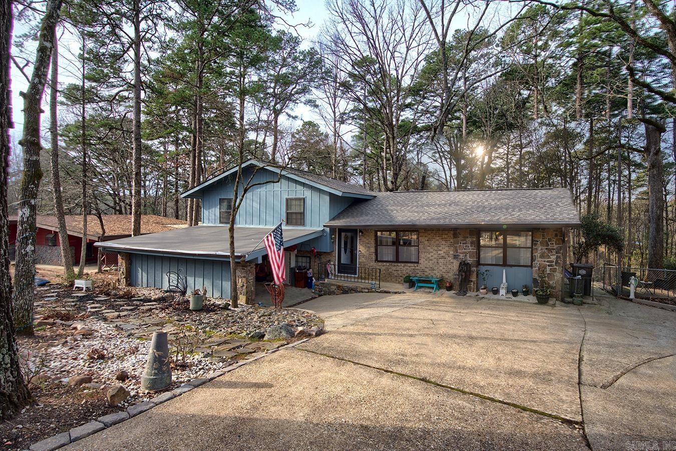 Have a growing family or feeling like the Brady Bunch with his, hers and theirs and need a lot of room? This four bedroom plus, split level, 1970s home might be just what you are looking for. Boasting many updates, this affordable home has four full bedrooms, two living areas, an office area, spaces for both formal and informal dining and a workshop. Add to that the beauty and safety of being in Hot Springs Village, and you may have just found your new home.