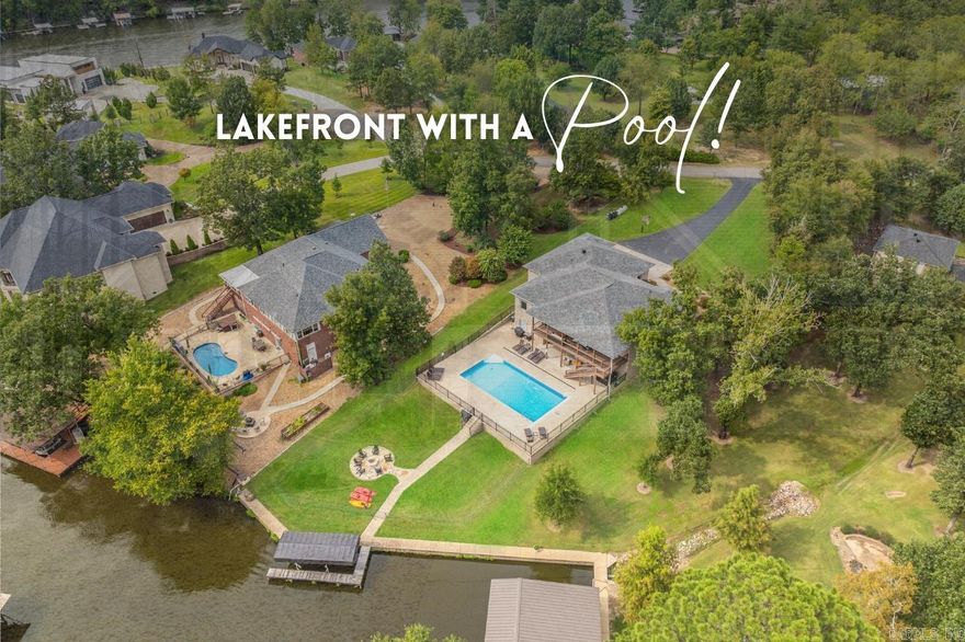 Welcome to 183 Rhema Point, a meticulously updated residence where luxury and functionality harmonize perfectly. This lakefront home features 4 bedrooms and 3 full baths, highlighted by a spacious master bedroom with a custom en suite bathroom boasting a zero entry shower and soaking tub, offering a serene retreat. Two full kitchens adorned with granite countertops and stainless steel appliances provide unparalleled convenience and style. Whether you're preparing meals for family gatherings or hosting guests, these well-appointed kitchens cater to every culinary need. Step outside to discover your private oasis, complete with a sparkling (heated) pool ideal for summer entertainment, a flagstone fire pit for cozy evenings, and a boat dock for water enthusiasts. Inside, custom bunk beds ensure comfortable accommodations for family and guests, while the renovated garage, heated and cooled, adds an impressive 1137 sq ft of versatile living space—perfect for a workshop, gym, or additional entertainment area. (4,945 SQFT total heated/cooled). Choose whether to use this incredible space to park or to play. Every detail has been thoughtfully designed for modern living and leisure. REMARKS