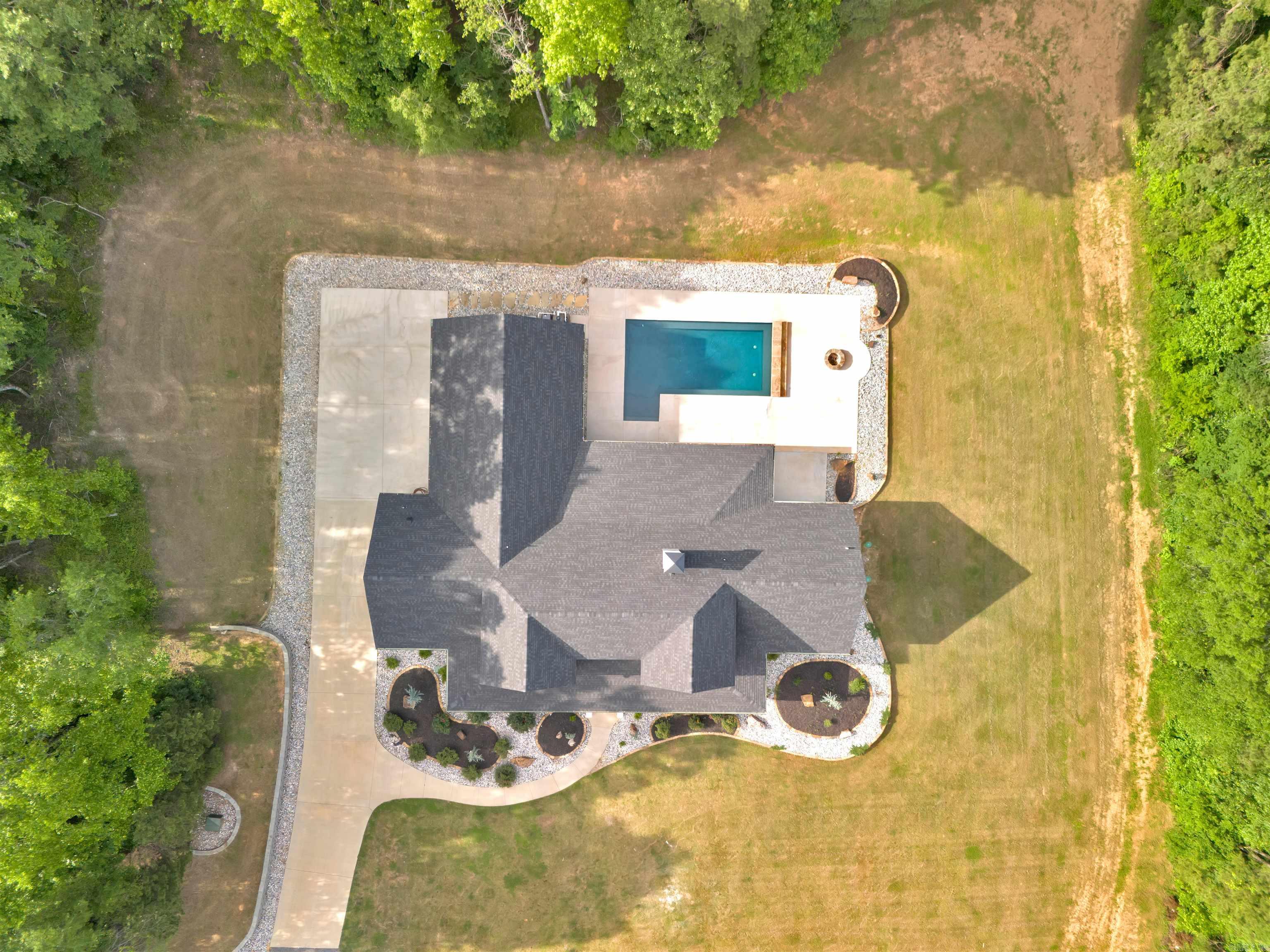 Welcome to this stunning 4,172 sq ft home built in 2022, perfectly positioned on 23.33 acres in scenic Paron, Arkansas. Situated between natural landmarks, Winona Wildlife Management Area is a short distance to the north, Ouachita National Forest is a short distance to the south, and Lake Winona is a short distance to the west—offering unmatched privacy and access to the outdoors. This custom-built home features 4 spacious bedrooms- each providing a private bathroom, an additional half bathroom, butler pantry, office and media room. Enjoy year-round relaxation in the heated pool with a tranquil waterfall feature. Additional highlights include a massive 80' x 40' shop with a 20' overhang—both the home and shop are equipped with energy-efficient spray-foam insulation. The home also includes unfinished, floored attic space with the potential to add even more finished square footage. Outdoors, you'll find two large ponds, abundant wildlife, and beautiful Trace Creek running north to south through the property—making it a true retreat for nature lovers. Get ready for fall hunting season and bring the ATV's! This property has it all with no restrictions!
