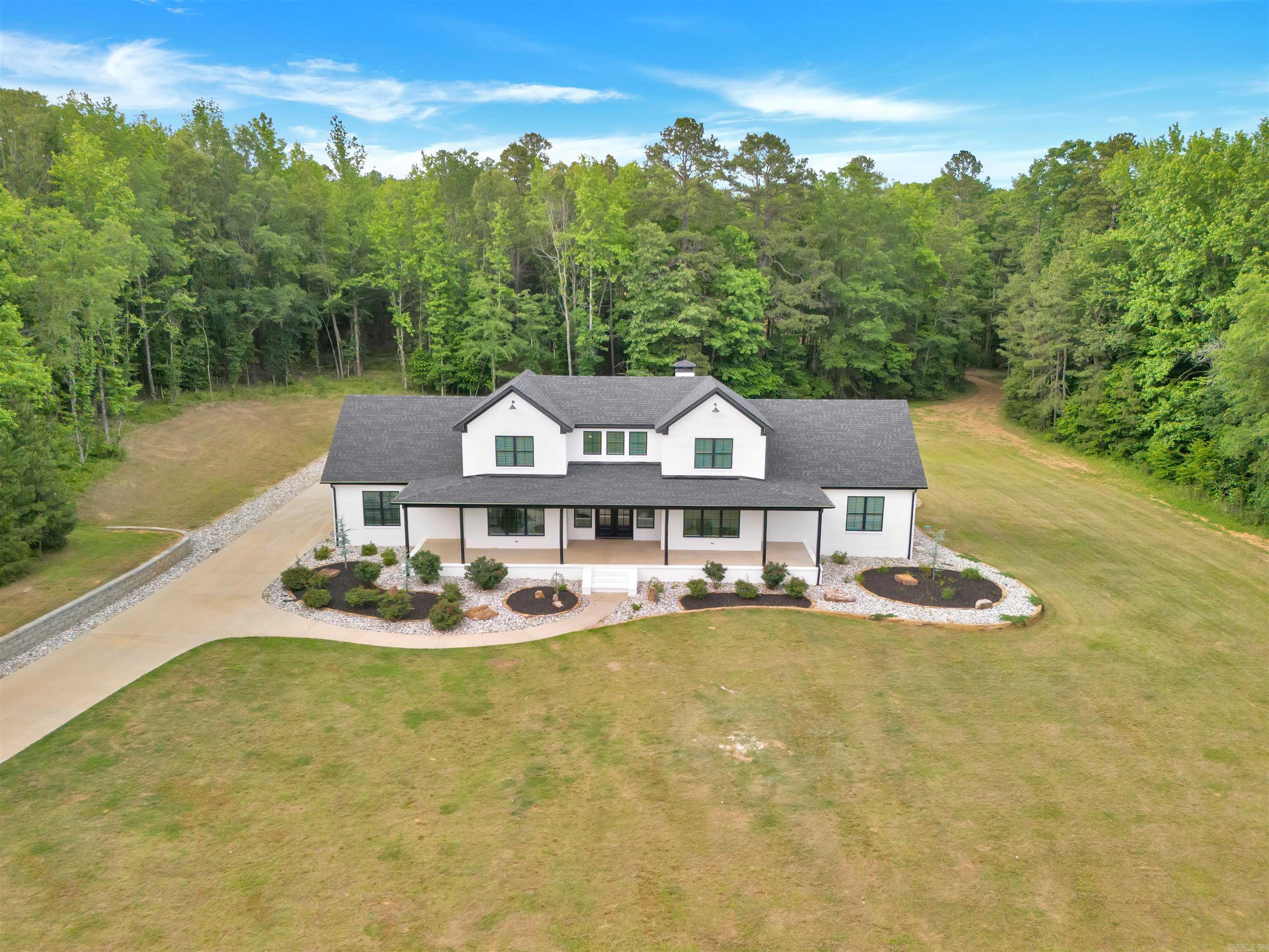 Welcome to this stunning 4,172 sq ft home built in 2022, perfectly positioned on 23.33 acres in scenic Paron, Arkansas. Situated between natural landmarks, Winona Wildlife Management Area is a short distance to the north, Ouachita National Forest is a short distance to the south, and Lake Winona is a short distance to the westāoffering unmatched privacy and access to the outdoors. This custom-built home features 4 spacious bedrooms- each providing a private bathroom, an additional half bathroom, butler pantry, office and media room. Enjoy year-round relaxation in the heated pool with a tranquil waterfall feature. Additional highlights include a massive 80' x 40' shop with a 20' overhangāboth the home and shop are equipped with energy-efficient spray-foam insulation. The home also includes unfinished, floored attic space with the potential to add even more finished square footage. Outdoors, you'll find two large ponds, abundant wildlife, and beautiful Trace Creek running north to south through the propertyāmaking it a true retreat for nature lovers. Get ready for fall hunting season and bring the ATV's! This property has it all with no restrictions!