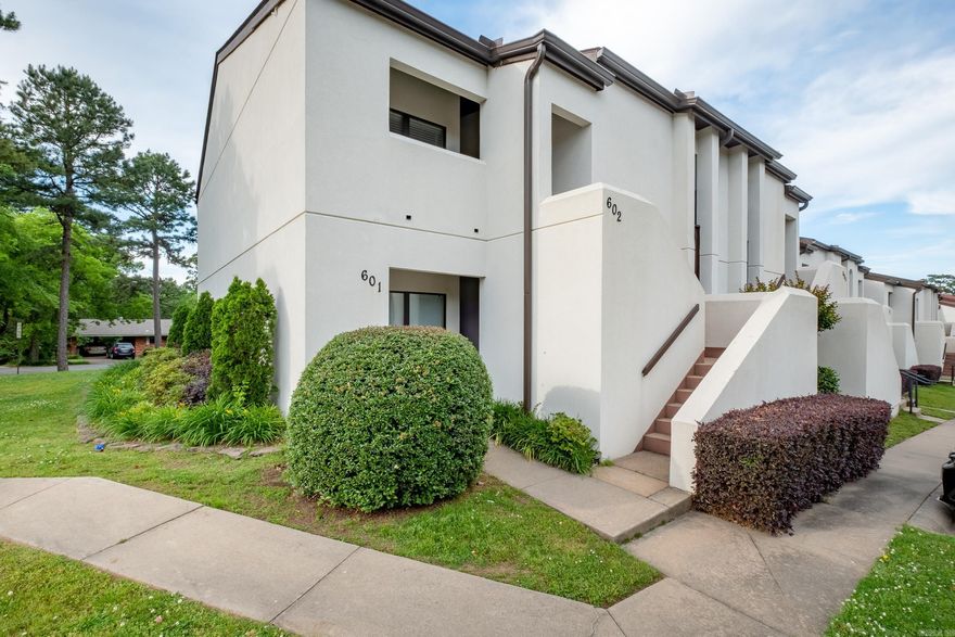 One of the very BEST! Wonderful condo with excellent floor plan, Large living with fireplace and open dining with high ceilings. 2 spacious bedrooms, 2 full baths. Granite in kitchen with nice appliances. Enjoy privacy and view from the balcony terrace.  Fabulous location conveniently located close to Mid-town and WLR. End unit with additional parking. Overlooking green area. Excellent common areas and pool!