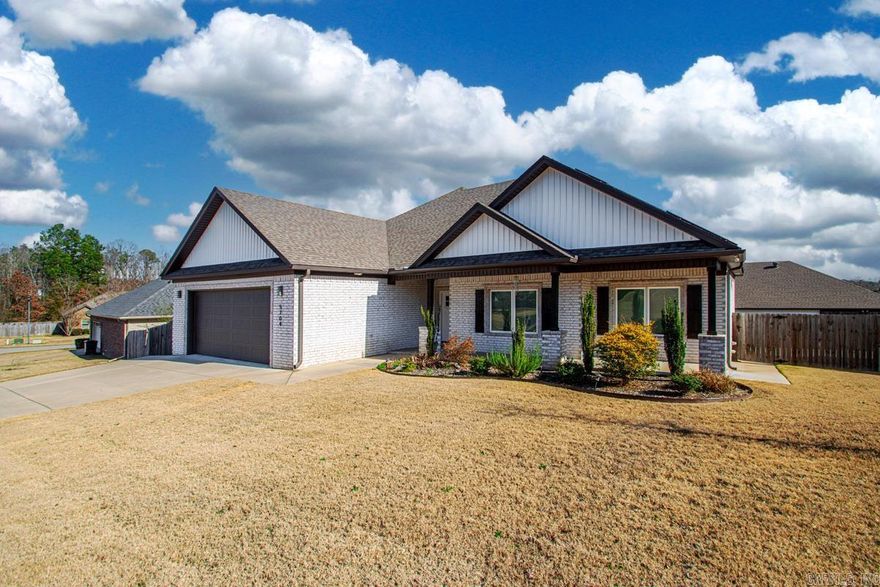 Welcome to this beautiful 4-bedroom, 2.5-bath home located in Bryant. An open floor plan highlights granite countertops, stainless steel appliances, and a large island perfect for gatherings. Tray ceilings and recessed lighting add charm to the living room and primary bedroom. The primary bathroom features a double vanity and his-and-hers closets, while the guest bath also offers a double vanity with a separate bath/toilet area. Outside, enjoy a covered patio and fully fenced backyard and a raised bed for your garden. The home also includes an extra parking pad connected to the driveway.