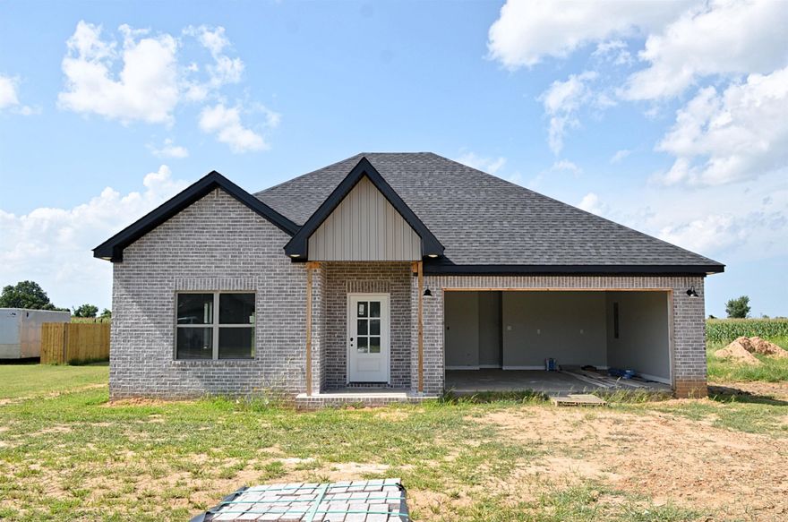 The construction process is lengthy! From breaking ground, pouring the foundation, framing, and brick. THEN the interior finally begins! With months of progress we are getting much closer to being able to welcome you to Small-Town Charm and Big-Time Comfort! This beautiful all-brick, 3-bedroom, 2-bathroom home is located in a friendly, established neighborhood where front porch waves and Friday night football are a way of life. It's the kind of place where memories are made and community still matters. Inside, you'll find a warm, inviting open-concept living area featuring a natural gas fireplace, perfect for cozy nights in. The kitchen offers modern style and functionality with: Granite countertops. A spacious island with built-in storage  A gas range for preparing home-cooked meals  The primary suite includes a walk-in tile shower and a soaker tub, ideal for relaxing at the end of a long day. Outdoors, you'll be surrounded by well-maintained homes in a neighborhood that encourages evening strolls, front porch conversations, and a true sense of community. Don't miss your chance to be part of it.