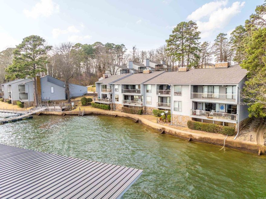 This lower level unit is located on the water's edge and features beautiful lake views, large covered deck, covered parking space and covered boat slip! This unit is mostly original with the exception of a new water heater and wood flooring but is perfect for someone wanting to put their interior design mojo to work and is priced well below recent sales.  It won't take much to make this gem really shine!