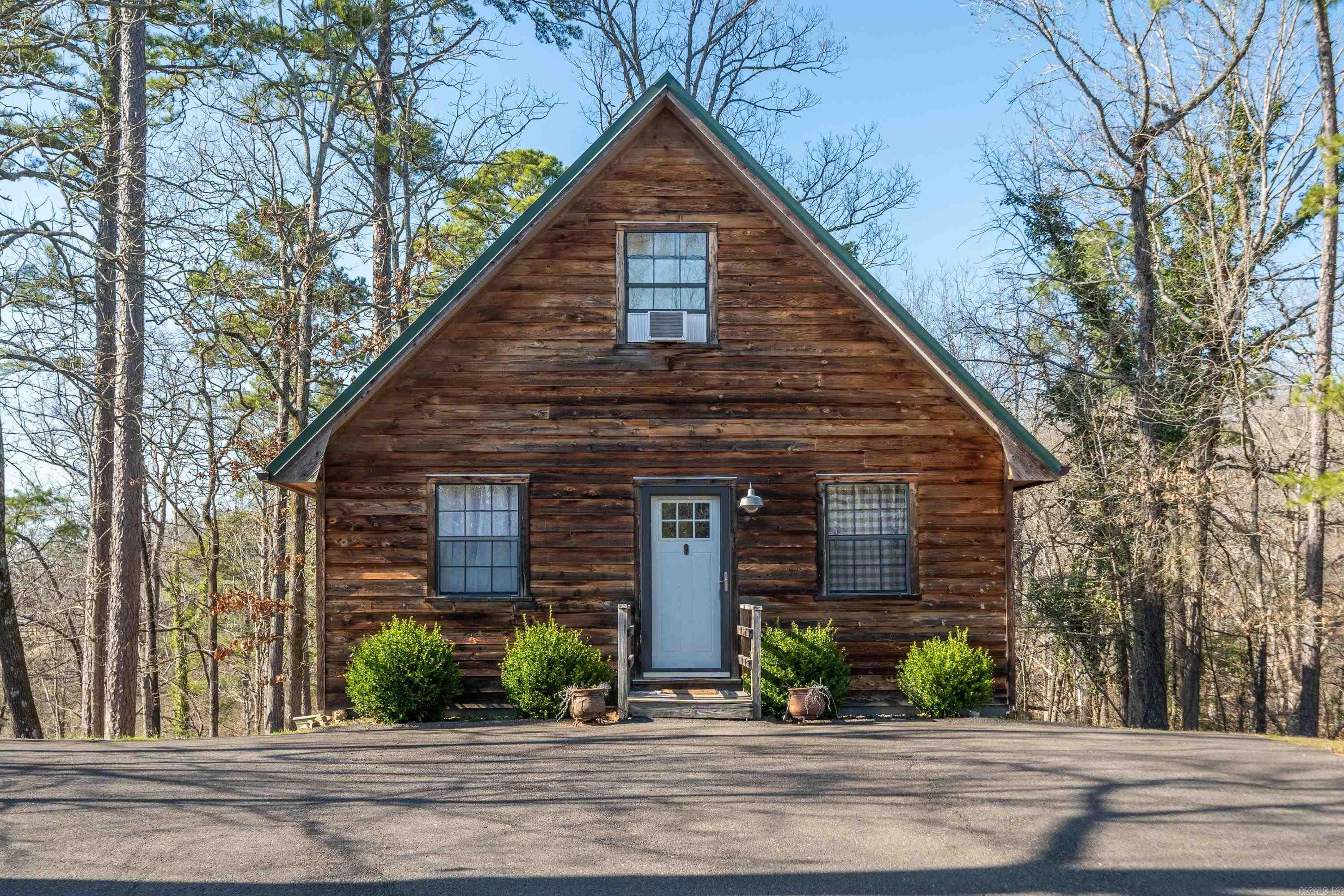 Tucked away in a quiet cove on Lake Catherine is where your dream cabin awaits. Choose which covered porch to relax on or have a seat next to the fire pit. This cabin offers high ceilings, 2 spacious bedrooms and 1 bathroom. Bonus space downstairs could be a nice office or game room. After a day on the lake you can park your boat and head into the open concept kitchen that's perfect for entertaining. Located just outside Hot Springs you are within minutes to restaurants, Oaklawn or downtown! This is a highly producing nightly rental so your possibilities are endless!
