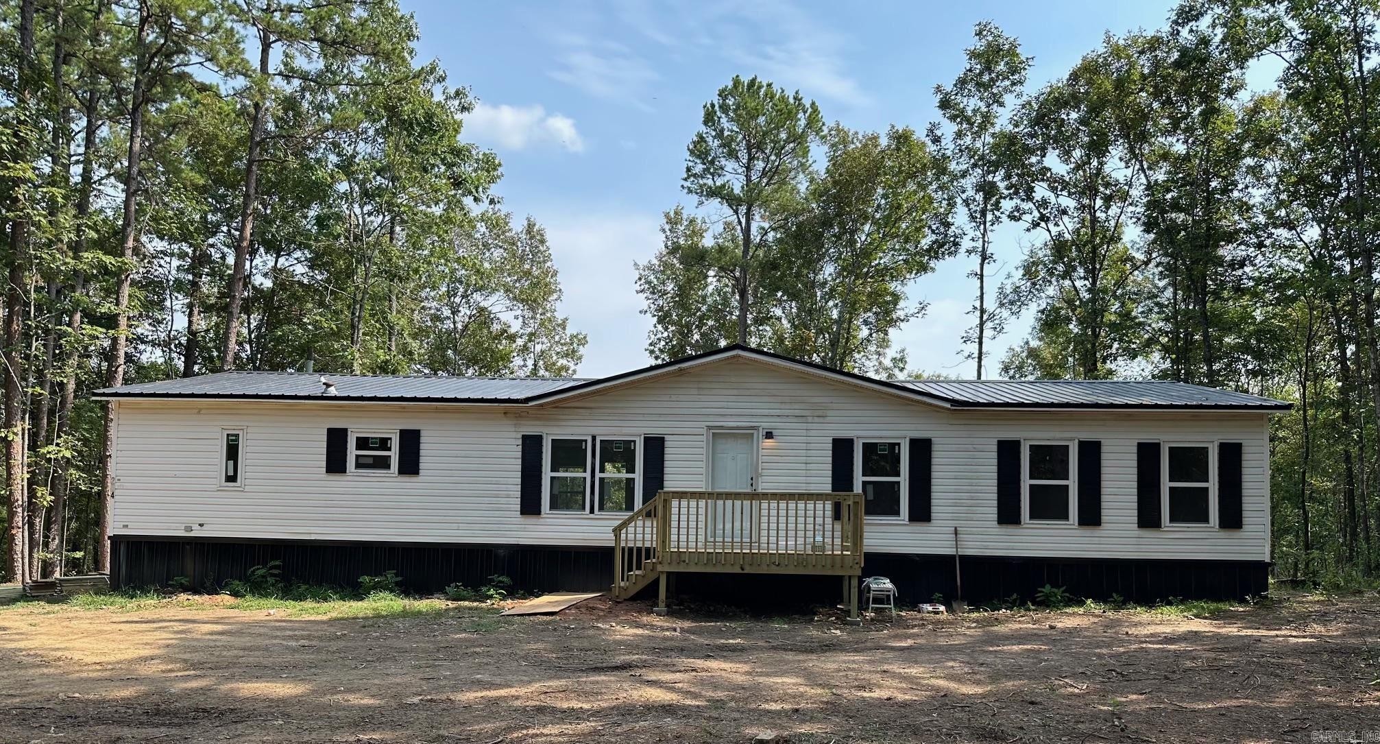 Bring the Fishing Poles!! Newly Remodeled Home close to Lake Barnett! New pet friendly luxury vinyl tile throughout the home, paint, kitchen cabinets, countertop, lighting, metal roof, windows, septic, inside and outside electrical panels, front deck and wrap-around deck for sipping morning coffee or watching the wildlife. Separate laundry room with half bath and large pantry right off the kitchen. Primary bedroom has a large walk-in closet and ensuite bathroom with room for your own makeup vanity. The 4th bedroom would make a great office or nursery. Come check it out today.