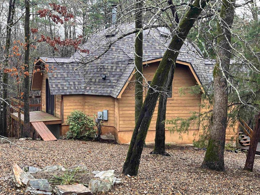 Rare DELCO-inspired octagon home offering striking architecture, vaulted ceilings, and a peaceful wooded setting with a seasonal creek visible behind the property.  Unique DELCO-inspired octagon home tucked into the natural beauty of Hot Springs Village! This distinctive 2BR/2BA, three-level home with garage offers vaulted ceilings, abundant natural light, and architectural character rarely found in the Village. Recent updates include a new roof and new skylights, enhancing both efficiency and brightness throughout the home.   Surrounded by trees for exceptional privacy, the property backs to a visible seasonal creek, creating a peaceful woodland setting. Enjoy the outdoors from the spacious deck and private balcony, perfect for relaxing, entertaining, or watching local wildlife. The unique octagon design, vertical layout, and connection to nature make this home ideal for buyers seeking something beyond the ordinary while still being close to all Village amenities.   If you've been searching for a home with architectural personality, peaceful privacy, and a true connection to nature, this DELCO style retreat is one you won't want to miss.