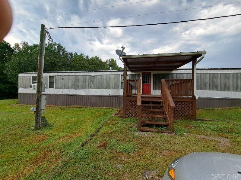 -2000 Clayton 16 x 80 mobile home with a metal roof over, partially furnished, kitchen appliances, washer & dryer, storage building, & shed -1,500 gallon septic tank -It comes with a travel trailer