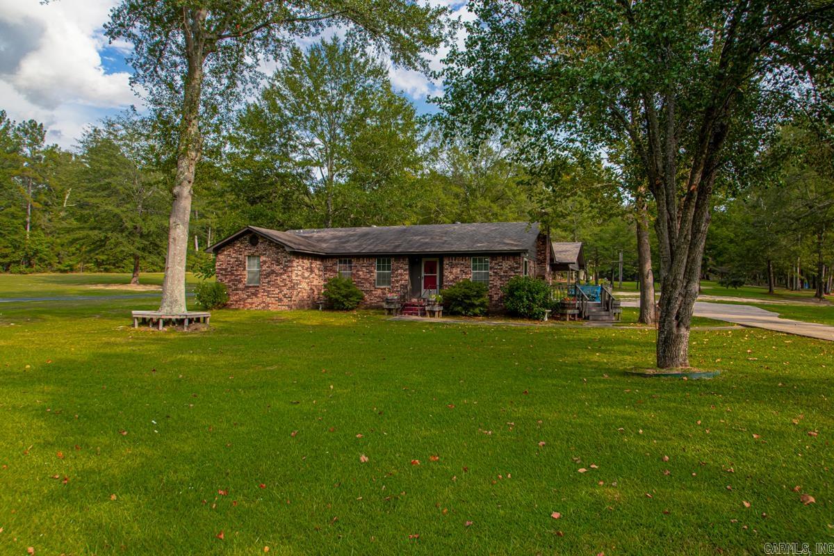 Discover comfort and convenience with this spacious home offering 3 bedrooms and 3 full bathes including a primary suite retreat with private sunroom access and gas burning fireplace, jetted tub, walk-in shower and split closet space. One bedroom is designed with built-in shelving and a desk-perfect for a home office or study. The open floor plan creates a bright, welcoming atmosphere, while the sun deck on the east side of the house provides the perfect spot for morning coffee and evening relaxation. Wood burning fireplace in living room with new flu insert. Additional features include storage off the carport and plenty of space on the 2.5 acre lot with room to build a shop. kitchen appliances are all new and in slate color. Located less than a mile from Interstate 30, this property offers an easy commute and is just 20 minutes from Hot Springs National Park and Oaklawn Park.