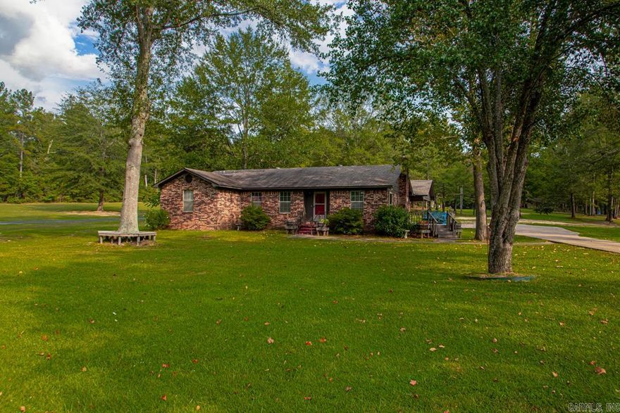 Discover comfort and convenience with this spacious home offering 3 bedrooms and 3 full bathes including a primary suite retreat with private sunroom access and gas burning fireplace, jetted tub, walk-in shower and split closet space.  One bedroom is designed with built-in shelving and a desk-perfect for a home office or study. The open floor plan creates a bright, welcoming atmosphere, while the sun deck on the east side of the house provides the perfect spot for morning coffee and evening relaxation. Wood burning fireplace in living room with new flu insert. Additional features include storage off the carport and plenty of space on the 2.5 acre lot with room to build a shop. kitchen appliances are all new and in slate color.    Located less than a mile from Interstate 30, this property offers an easy commute and is just 20 minutes from Hot Springs National Park and Oaklawn Park. AGENTS see Agent remarks