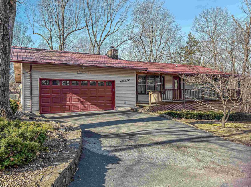 Charming 2-bedroom, 2 bath home located less than 5 miles from town.  Practical, well-designed layout with comfortable living spaces.  Features include a durable metal roof, carpet and tile flooring, cozy wood-burning fireplace, and a covered deck perfect for relaxing or entertaining.  Partial walkout basement adds extra space and functionality.  A great blend of convenience and comfort.