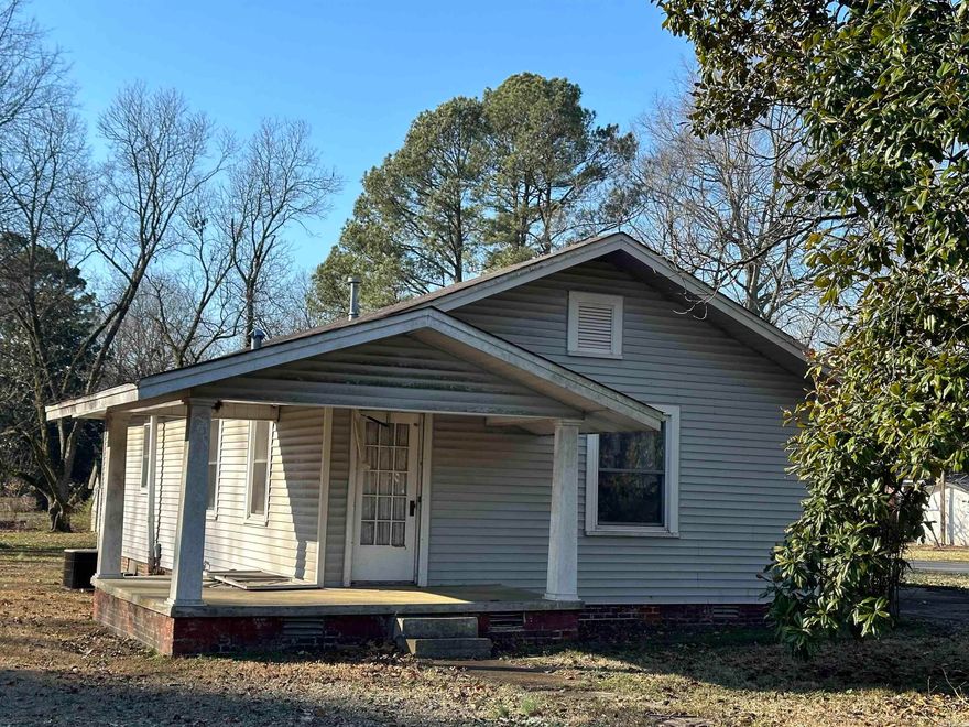 Small home built in 1939 - could be neat investment property! Large eat in kitchen and front room with built-ins and an enclosed back porch add to the potential living area. Hardwood floors and vinyl floor covering throughout and the interior walls of original panelling add classic charm and character.   Carport is good for 2 vehicles and the drive way allows for entry off of Adams or Monroe Street! There is also a storm cellar close to the home - check to your own satisfaction.