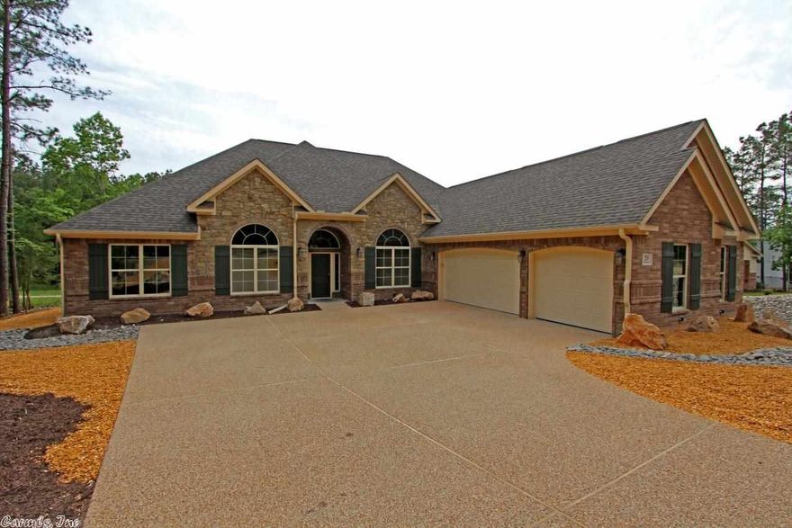 This is the Carriage Chapmond plan.  Huge windows, Tons of crown and fluted trim and volume ceilings, the look that Carriage is known for.  Bonus Room upstairs.  The  master bedroom features a unique sitting area with a view to die for.  The master bath has a walk in "Roman Shower" and a huge closet with builtins.  The kitchen has all the latest and greatest including stainless appliances and gorgeous custom cabinetry.    A little off the beaten path, this lot features a gorgeous private setting.