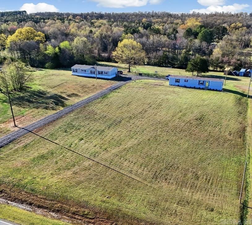 Unlock the ultimate homesteading dream with this rare 4-acre property, featuring TWO beautifully appointed manufactured homes built in 2024, thoughtfully designed for flexibility and country living. Nestled on a generous lot, this expansive retreat offers endless opportunities for self-sufficiency, family living, or even passive income. The centerpiece is a stunning double-wide, set on a permanent foundation, boasting 2,100 square feet of spacious comfort. With 5 bedrooms and 3 bathrooms, this home is perfect for a growing family or multi-generational living. Complementing it is a charming Clayton single-wide, offering 1,100 square feet with 3 bedrooms, 2 bathrooms, and a convenient carport—ideal as a rental to offset your mortgage or a cozy spot for extended family. Beyond the homes, this property is a homesteader’s delight. A 10x24 homeschool/craft space provides a dedicated area for learning or creating, while two 8x40 storage containers—one with electric—offer ample room for tools, projects, or supplies. A fenced dog area keeps pets secure, and the vast acreage invites gardening, livestock, or simply letting kids run free under wide-open skies. AGENTS, SEE REMARKS!!!