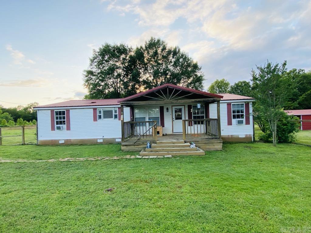 This charming 3-bedroom, 2-bath home sits on a spacious 1-acre lot in a quiet neighborhood. This home offers a fenced in front yard, a covered front and back porch, a carport, a storm shelter and much more. Come see this beautiful home today!