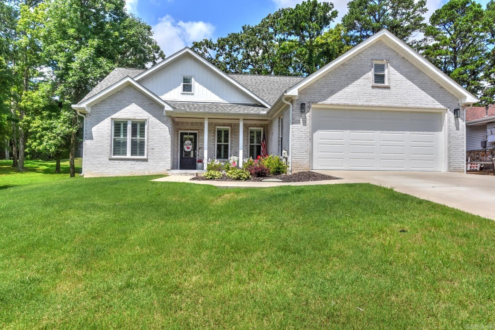 Welcome to your dream home, perfectly situated along the Indian Hills Golf Course! This beautifully crafted, single-level brick residence boasts a bright & airy open-concept design, ideal for both relaxing & entertaining. The home features a sought-after split floor plan, offering privacy & comfort for family & guests. Step inside to discover soaring 9’ ceilings, luxury vinyl flooring, & gorgeous quartz countertops throughout the modern kitchen & bathrooms. Enjoy spa-like relaxation in your tiled showers & retreat to the spacious covered patio—perfect for sipping your morning coffee or unwinding as you watch golfers pass by with serene, manicured views. Bonus! An upstairs area currently used for storage offers excellent potential. Easily finish it out as an extra bedroom, game room, or home office—the choice is yours! Outdoor enthusiasts will love being just 10 minutes from Greers Ferry Lake, renowned as one of the cleanest lakes in the United States, offering endless boating, fishing, & water recreation opportunities. The vibrant community of The Bay features an abundance of amenities to suit every lifestyle: ATV & hiking trails & pickleball, This home blends comfort & luxury.