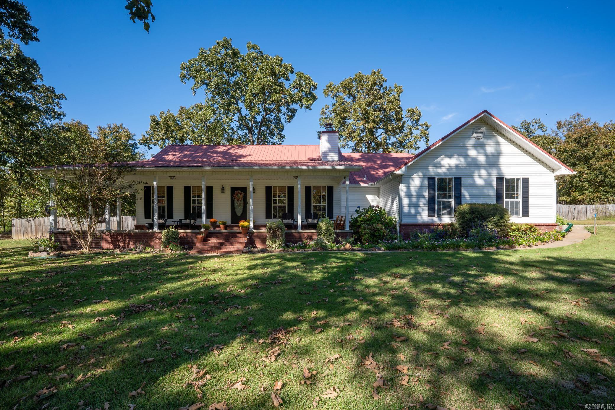 Absolutely pristine property on 2 acres in Conway! This beautifully updated 3-bedroom, 2-bath home offers the perfect blend of charm, comfort and modern touches. The inviting wraparound front porch welcomes you as you step into the living room with a cozy wood-burning fireplace, built in shelving and new luxury vinyl flooring and paint throughout. The kitchen and dining area are open and bright, featuring stainless steel appliances, new backsplash, updated sink and faucet, bar seating with pendant lighting. The primary suite is a nice size with an en-suite bathroom offering double sinks, large vanity with storage, beautiful tiled walk-in shower and walk-in closet. Two additional guest bedrooms share an updated hall bath. Thereās also a convenient mudroom and laundry area with extra storage. Step out back to the generous screened-in porch, perfect for relaxing or entertaining while overlooking the peaceful acreage. Outside, youāll love the raised garden beds, fruit trees and additional outside storage ideal for anyone who loves outdoor living. This property truly offers the best of country living with easy access to Conway amenities!