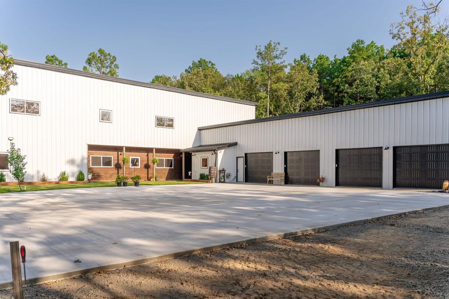 This stunning barndominium is located on 7.58 acres in the Mayflower school district in Faulkner County. The property features a 3153 sqft living space, 4 bedrooms, 2.1 bathrooms and a flex room within an open floor plan. The main level features your  spacious living room, a dining room, and a kitchen with stainless steel appliances, laundry/mud room, master suite with a flex room attached. This property also has a 4 car garage, a storm shelter, mature trees, walking trails and fruit trees.  Custom built barndominium with 30-year warranty on metal. Columns into ground covered with Chromium for lifetime termite repellant. Tankless water heater for fast, hot water on demand. Storm shelter for 6-8 people for added safety. 12-camera security system for peace of mind. 500-gallon propane tank for reliable heating and cooking. Fiber optic internet access for high-speed connectivity. Top-of-the-line appliances for energy efficiency. 2 electric panels and 2 HVAC units for split environment upstairs/downstairs.