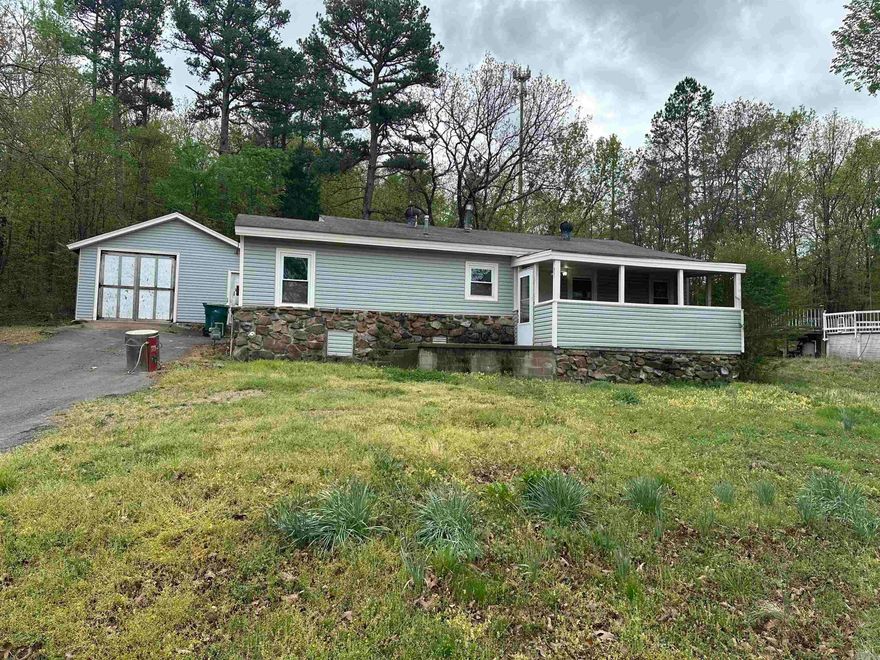 Great starter home on a little over a half acre of land or an investment opportunity to add to your rental portfolio.  Home has easy access to I40, near Burns Park.  Home and a one car garage on one lot and above the ground swimming pool with deck on the second, lots are being sold as one property. Front of home is manufactured, back of home is stick built, back area is the living room and master bedroom. Seller reports home to be on a permanent foundation.  Home has FRESH PAINT and New FLOORING! Kitchen has nice wood cabinets and newer formica countertops! NEW FIXTURES throughout! Living area has custom sealed rock flooring with gas fireplace and vaulted ceiling. Home has updated windows.  Bathroom is not completed entirely, will be before close with NEW TILE around shower/tub combo.  Updated  bathroom sink! This is a great price point for a first time home buyer!  Book your showing today! (measuring is approximate, measuring is suggested)