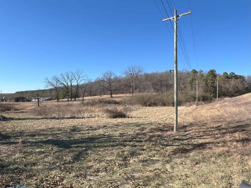 This property features 9.12 acres of Highway 71 frontage, offering a good mix of pastureland and wooded hillside. At the top of the hill are a few possible building sites for a house, along with a great view. This land would be ideal for a small farm or business. Utilities are available to the property. It will need a septic system. Please note that the old barn on the property is not usable. Agents see remarks