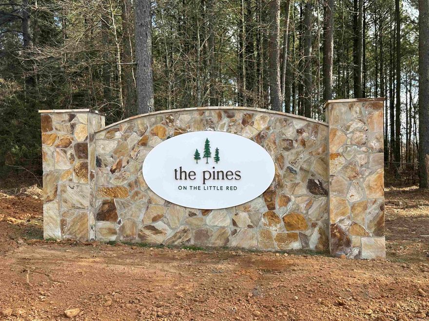 Lot #4 in The Pines on The Little Red. (Riverfront lot.)  The Little Red River's newest, premier riverfront property just 3 miles from Pangburn.   World class trout fishing right outside your back door! This stretch of the Little Red River is known for both quality and quantity of trout. There are numerous rainbow trout and brown trout that call this stretch of the river home. This property boasts access to your own private, gated boat launch. Located 3.2 miles upstream from the Ramsey's Access, and 2.6 miles downstream from the Dripping Springs Access. Lot #4. See map.  If you know, the Little Red River is home to many aquatic species, and also many other species unique to a tailwater ecosystem. If you don't know, it's not uncommon to see bald eagles, river otters, whitetail deer, turkey, and a multitude of migrating waterfowl. There are many resident Canada geese and wood ducks too! It's truly a sportsman's paradise. This riverfront property is tucked away and protected by large, mature pine trees on the north side, and the Little Red River on the south side. You even have a beautiful view of Round Mountain across the river to the east.