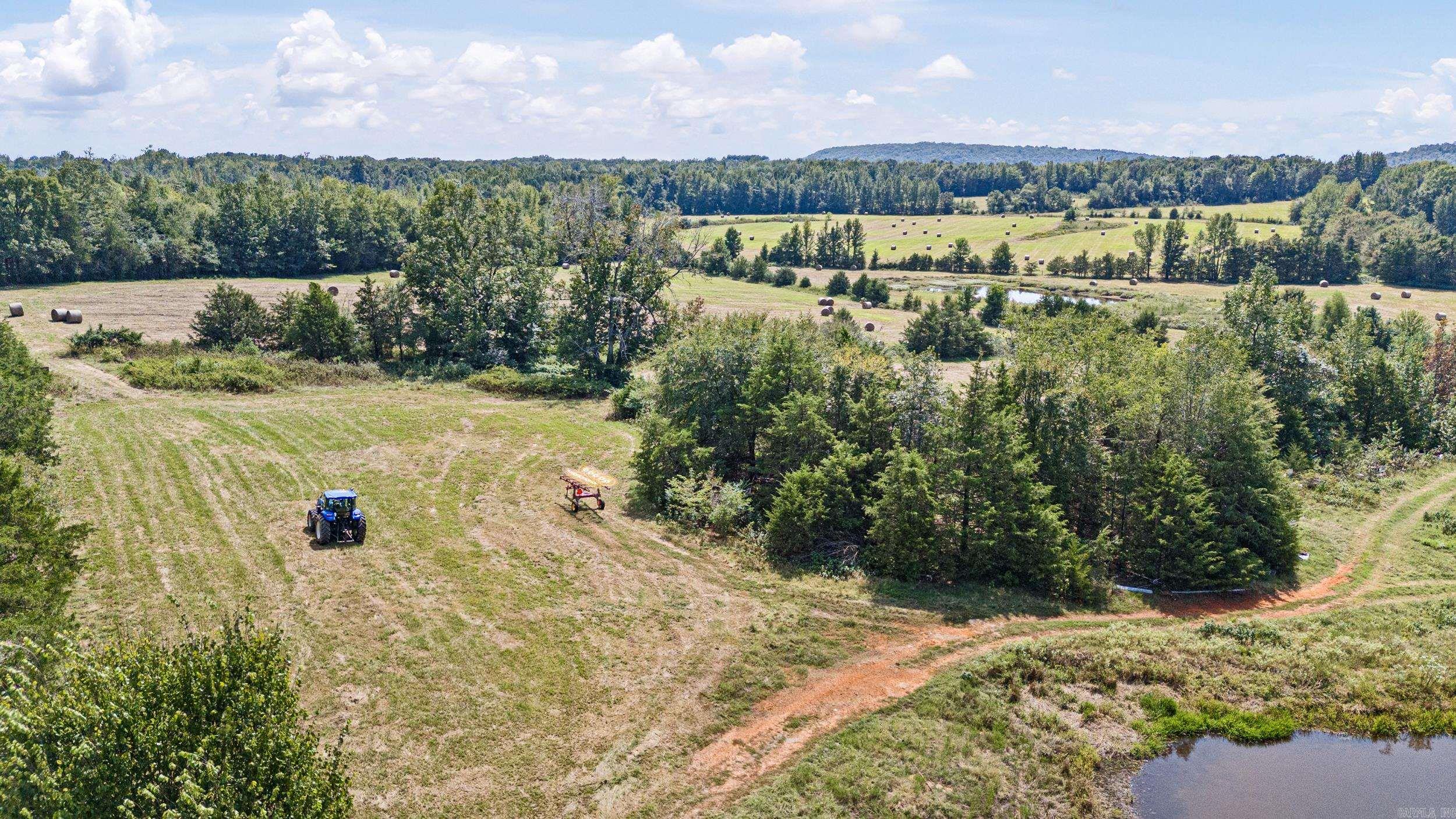 74.30 Acres Located on State HWY 247 complete with great views, ponds, pasture and woods. Easy access to interstate 40 East or West from here. Hay barn with some fence. NO MINERALS TO CONVEY. DEED RESTRICTION NO MOBILE HOMES. Cattle, recreational or just the peace and quiet countryside can all be found on this unique property 1st time ever offered! Some pictures may show a portion of TRACT 2 also for sale MLS# 25038296