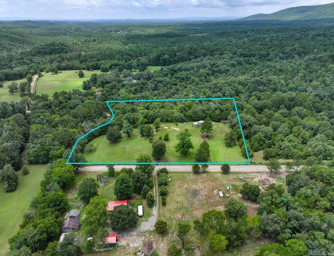 NEAR LAKE OUACHITA - 5 ACRES WITH MOUNTAIN VIEWS, CREEK, AND UTILITIES! Escape to your own piece of paradise! This beautiful 5 acre property offers mountain views and a peaceful setting to build your dream getaway cabin, investment property, or homestead. Just 7 minutes from Lena Landing Recreational Area and Northshore Marina - the second largest marina on Lake Ouachita - youāll have quick access to boating, fishing, and water fun all year long. A picturesque creek borders the property, adding to the natural charm, and the property is just minutes from Hot Springs Village's shopping and dining. The land comes equipped with utilities, septic, well water, and fencing with a gated entrance - ready for your plans to take shape. Mobile homes are allowed, giving you flexibility for either full-time living or a weekend escape. If you're looking for scenic views, outdoor adventure, and quiet country living, this one checks all the boxes. Agents - please register/schedule all showings with Showing Service.