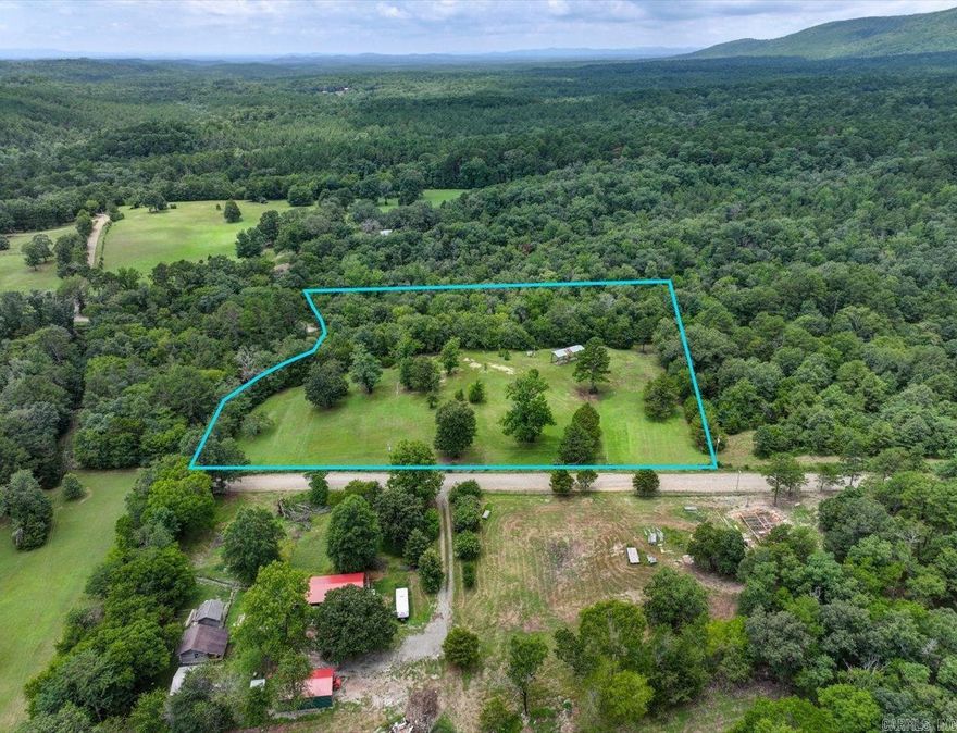 NEAR LAKE OUACHITA - 5 ACRES WITH MOUNTAIN VIEWS, CREEK, AND UTILITIES!   Escape to your own piece of paradise! This beautiful 5 acre property offers mountain views and a peaceful setting to build your dream getaway cabin, investment property, or homestead. Just 7 minutes from Lena Landing Recreational Area and Northshore Marina - the second largest marina on Lake Ouachita - you’ll have quick access to boating, fishing, and water fun all year long.  A picturesque creek borders the property, adding to the natural charm, and the property is just minutes from Hot Springs Village's shopping and dining. The land comes equipped with utilities, septic, well water, and fencing with a gated entrance - ready for your plans to take shape. Mobile homes are allowed, giving you flexibility for either full-time living or a weekend escape.  If you're looking for scenic views, outdoor adventure, and quiet country living, this one checks all the boxes.  Agents - please register/schedule all showings with Showing Service.