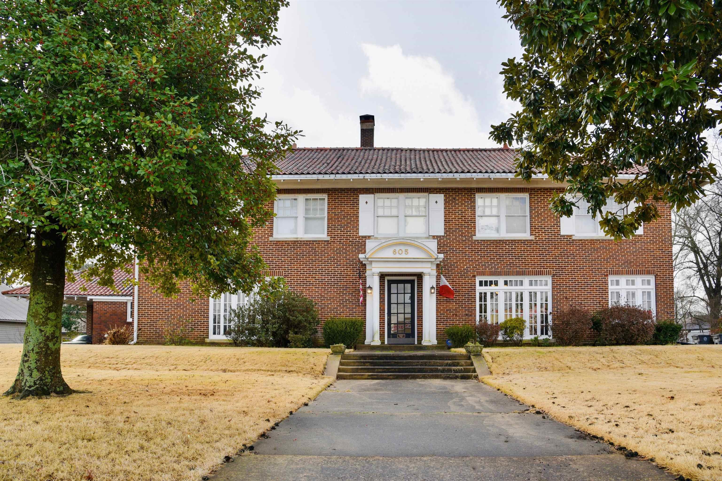 Historic Colonial Revival Home in Downtown Searcy ā A Rare Opportunity Awaits! Step back in time and embrace the charm of this exquisite Colonial Revival home, built in 1923 and steeped in history. Located near Harding University, this stunning property is a once-in-a-lifetime opportunity to own an important piece of Searcy's heritage, beautifully located near the heart of downtown. This grand residence boasts 7 bedrooms and 7 bathrooms, along with 4 half baths, making it the perfect setting for a bed and breakfast, wedding venue, or event space. Each room is infused with character and historical elegance. A magnificent porte-cochere greets guests, leading to an elaborate entry featuring elegant sidelight windows, classic pilasters supporting an entablature, and an arched pediment that speaks to the homeās architectural significance. Equipped with a fully updated commercial kitchen, this property is the perfect venue for weddings, bridal luncheons, parties, and special gatherings, each leaving a mark of grace and beauty. This home has been listed on the National Register of Historic Places since 1982, reinforcing its significance within the community. This property is ready to go!