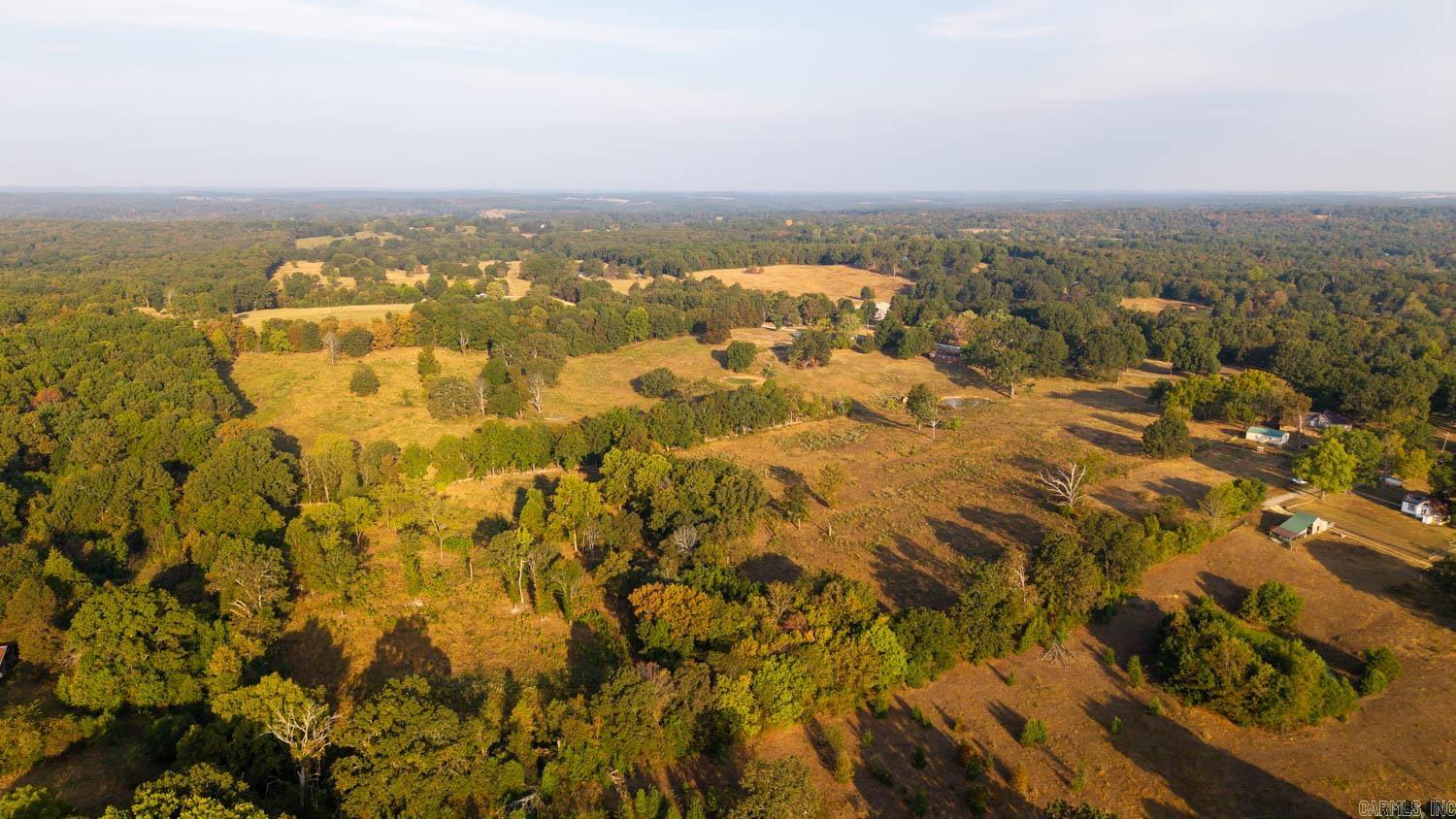 Acreage, Pasture, and Woods – 32 Acres with Prime Potential Welcome to this 32-acre property located just outside the city limits, offering the perfect blend of rural living with the convenience of nearby urban access. With city water and rural electric already available, this land is ready for development or for creating your own private retreat. The property features excellent paved road frontage, making it easily accessible and providing strong building site options for your dream home or future investment project. The acreage presents a balanced mix of open pasture and wooded areas, offering versatility for multiple uses. Over half of the land is open and currently suitable for livestock grazing, with three ponds already in place to provide reliable water sources. The wooded portions not only add character and privacy but also make this a great hunting property, with abundant wildlife and natural cover. This land is full of opportunity—set up your own farm, hobby farm, or simply enjoy the peace of country living just minutes from town. For developers, the location and layout make this a prime opportunity for future growth or subdivision potential. Outdoor enthusiasts will lo