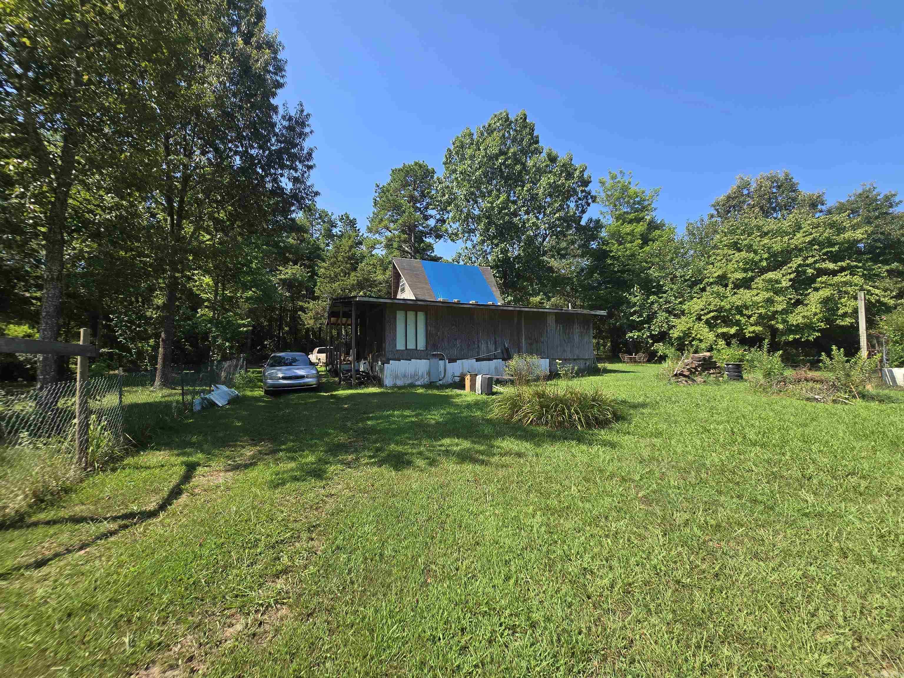 This beautiful 5-acre property is a rare find, offering a quiet, private setting with endless potential. What sets it apart is the presence of two separate homesites, each with electric, septic, and city water already in placeāan uncommon feature on unrestricted land. A small cabin sits on the property, livable as-is and ideal for temporary housing while you build your dream home. A year-round creek flows along the back of the land, creating a peaceful and scenic backdrop. You'll also find two wells for additional water access and a large storage shed for tools or equipment. For those looking for even more space, an adjoining 18 acres are also available for sale.