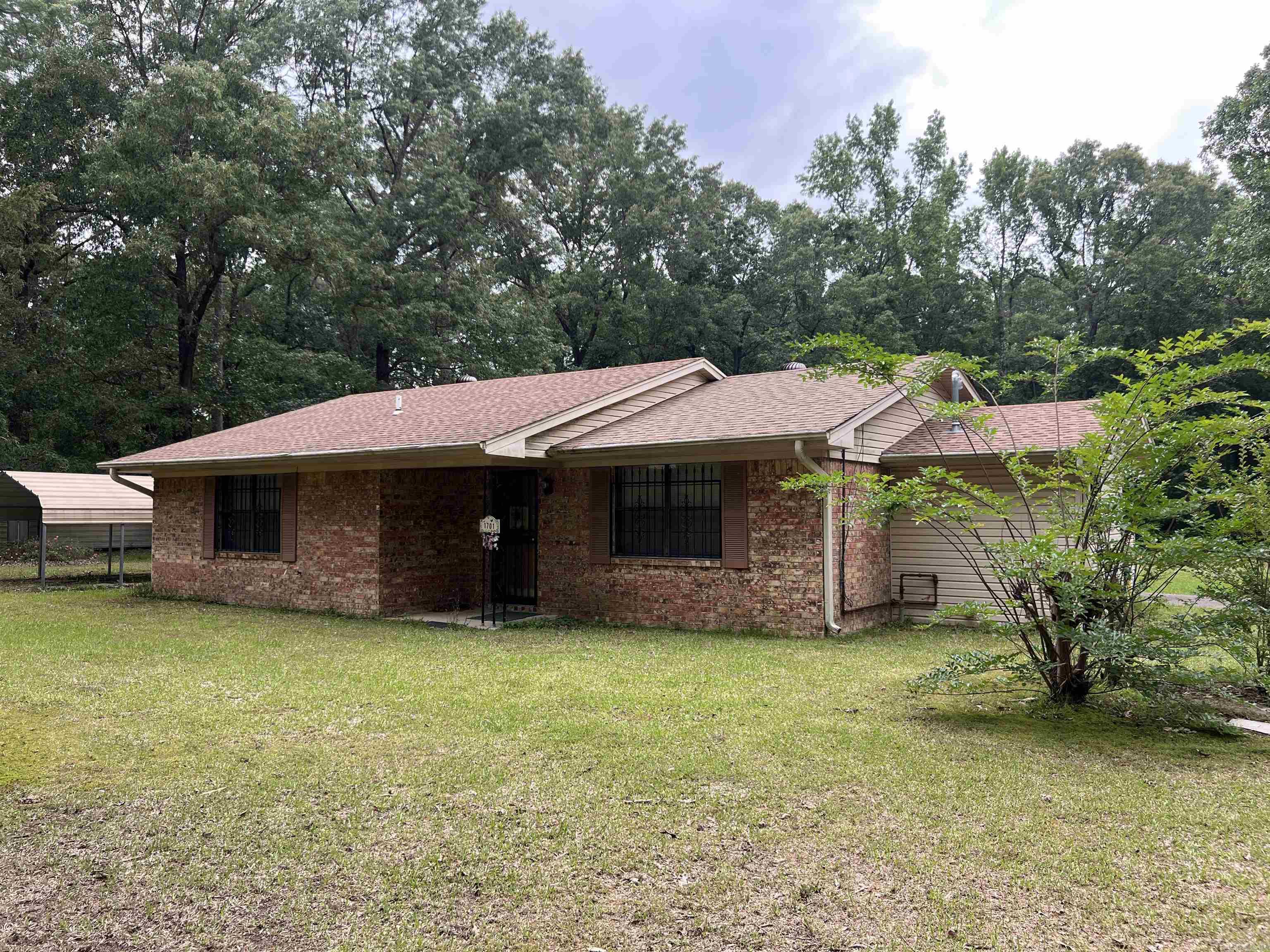 Welcome to this clean and well-maintained 3-bedroom, 1-bath brick home nestled on 3.86 acres of peaceful countryside. This charming residence offers a comfortable layout with a nice-sized living room, a functional and attractive kitchen, and generously sized bedrooms featuring ample closet space. Enjoy the convenience of a dedicated laundry room, a covered carport with an attached storage room, and an additional storage shed for all your tools and equipment. The partially fenced-in yard provides plenty of room for pets, gardening, or outdoor entertaining. Whether you're looking for space, privacy, or the charm of country living, this property offers it all with room to grow. See Agent Remarks