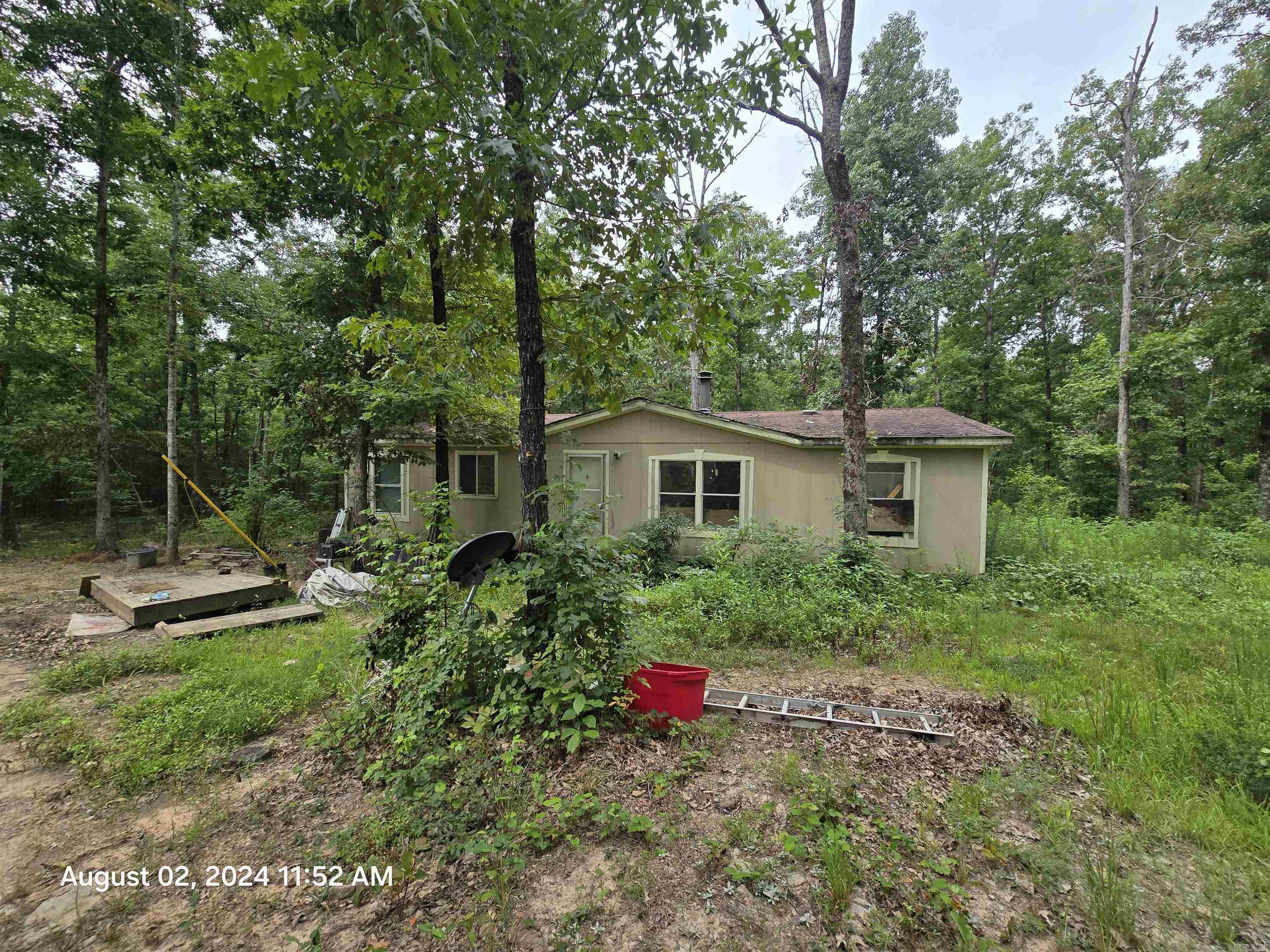 Embrace the beauty of the Ozarks with this 10 acres m/l property located in Clinton, Arkansas. Surrounded by natural landscaping this tract of land offers a truly enchanting setting to built your forever home or weekend camping spot. The land is equipped with essential amenities, including water, power and septic, ensuring convenience for your future plans. Although an old mobile home is present on the property, it is in need of removal or significant renovation. However, with this blank canvas, you have the opportunity to build the home of your dreams and create your own private oasis. Immerse yourself in the serenity of the Ozarks, explore the possibilities for outdoor activities, and enjoy the peace and tranquility that this property offers.