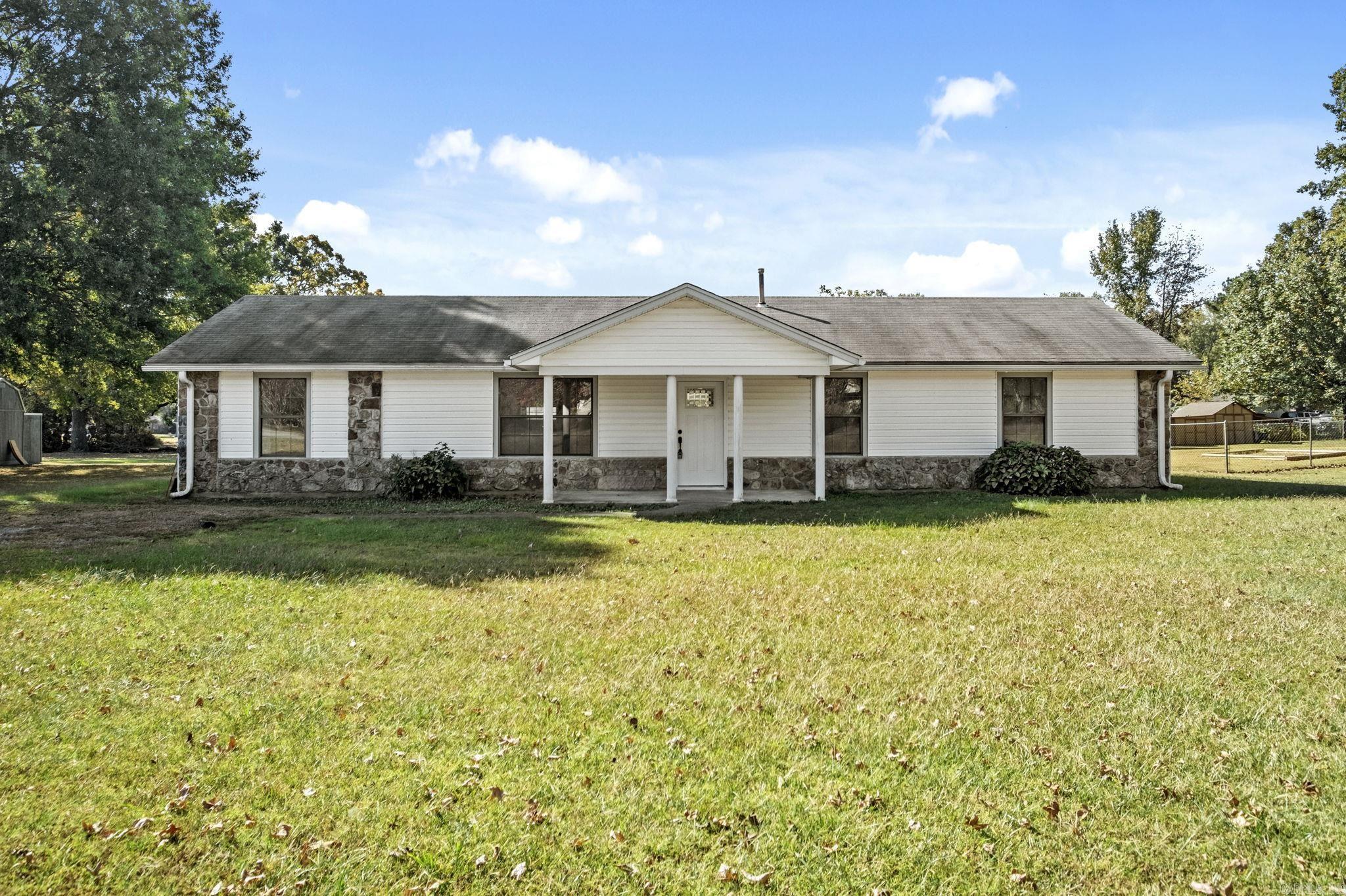 Welcome to your dream home! This beautiful 4-bedroom, 2-bath home sits on a spacious 1-acre lot, offering the perfect blend of peaceful country living and modern conveniences. Designed with accessibility in mind, the layout can easily accommodate a handicap-friendly design, ensuring comfort for all. Step inside to find luxury vinyl plank (LVP) flooring throughout, providing both style and durability. The large living spaces are perfect for entertaining, while the bedrooms offer plenty of room to relax. Outdoors, enjoy the expansive yard with endless possibilities, whether it's gardening, family gatherings, or simply soaking in the serene surroundings. Safety is a priority here, too—this home features a storm shelter, offering peace of mind. Square footage approximate, please measure. Seller will consider owner finance. Please inquire for more information. Agents see remarks.
