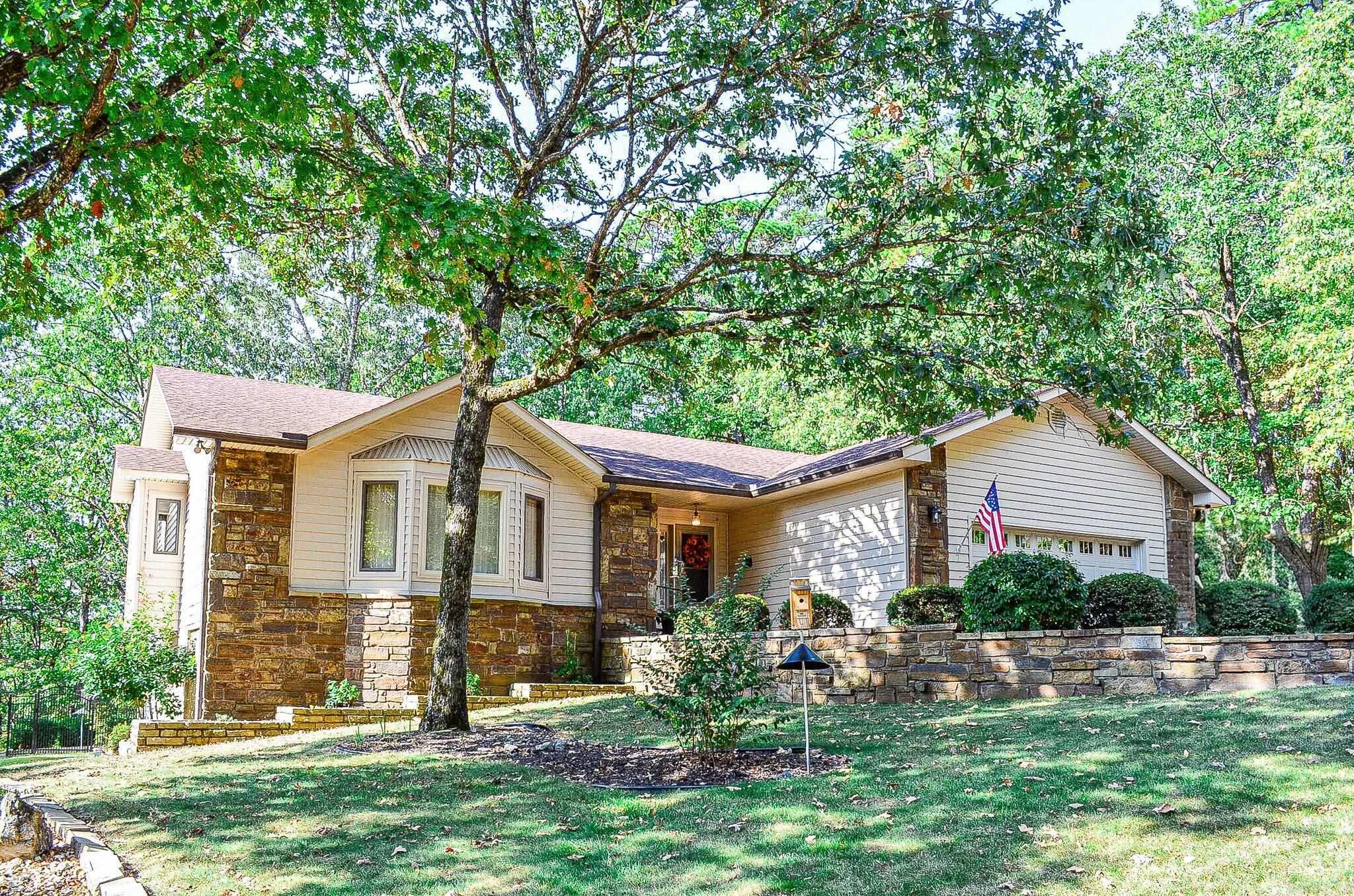 Enjoy your peaceful home with winter lake views of Cortez and adjacent lot that conveys. Spacious home with 4 Bedrooms and 3 full baths. Entry opens to large great room with vaulted ceiling, wood burning fireplace, kitchen with gas cook top, dishwasher, trash compactor and Refrigerator which conveys. Kitchen is open to eat in dining area, Arkansas Room and Great Room. Arkansas room opens to large deck. Laundry room with extra storage and sink. Washer and Dryer to convey. Primary bedroom and bath with dual sinks, walk in shower and new fixtures. Guest bedroom on main floor with walk in closet and built ins currently being used as office. Main floor with full bath. Lower level has two bedrooms, full bath with walk in shower. Lower level great room with wood burning stove, refrigerator, cook top and bar sink. Lower level opens to patio. Large storage area in lower level. Outdoors enjoy the beautiful landscaped yard,  and vista views from your patio or upper level deck with awning. Large workshop with outside access. Whole home generator and 500 gallon propane tank. Fresh paint throughout this home and Roof 6 yrs old. HSV new member one time Buy in Fee $1500.00.  Agent see Remarks.