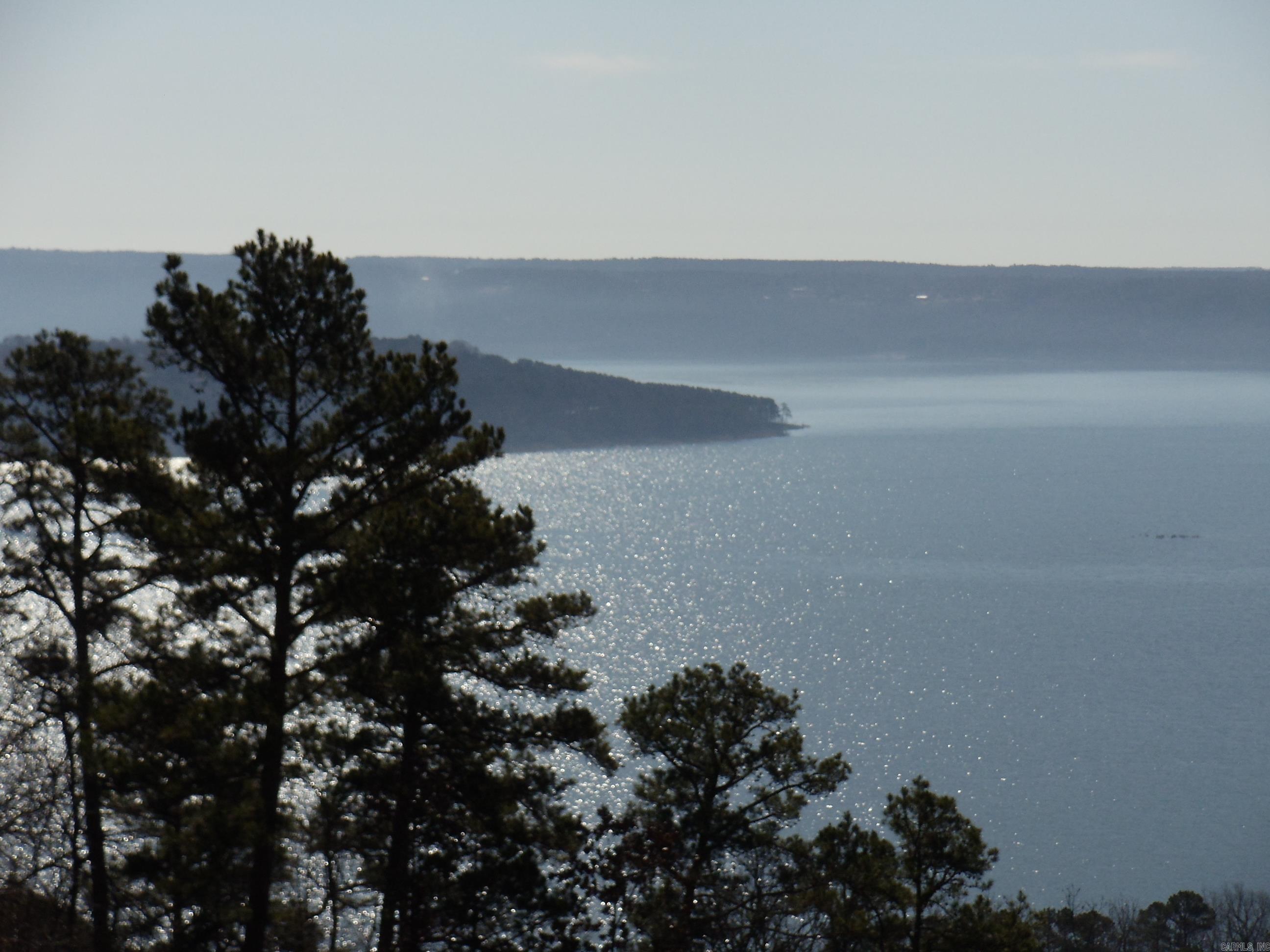 ABSOLUTELY BREATHTAKING BECAUSE ALL YOU SEE IS LAKE. NOTHING ON THE MARKET CAN MATCH IT IN MY OPINION. YOUR ON THE MOUNTAIN WHERE YOU CAN WATCH THE EAGLES SOAR, THE SAILBOAT RACES, SEE DOWN THE NARROWS, LOOK ACROSS AT SHILOH, WATCH THE SUNSET OVER SUGARLOAF MTN, SEE MOUNTAINS IN THE BACKDROP OF THE LAKE AND LOOK OVER THE TOWN OF GREERS FERRY. THIS LOT IS A RARITY ON THE MARKET. Lot considered lakefront but you are on a mountain an you cant get to lake. There is nothing between you and the lake. Septic approved already. Launching ramp near for your boat.