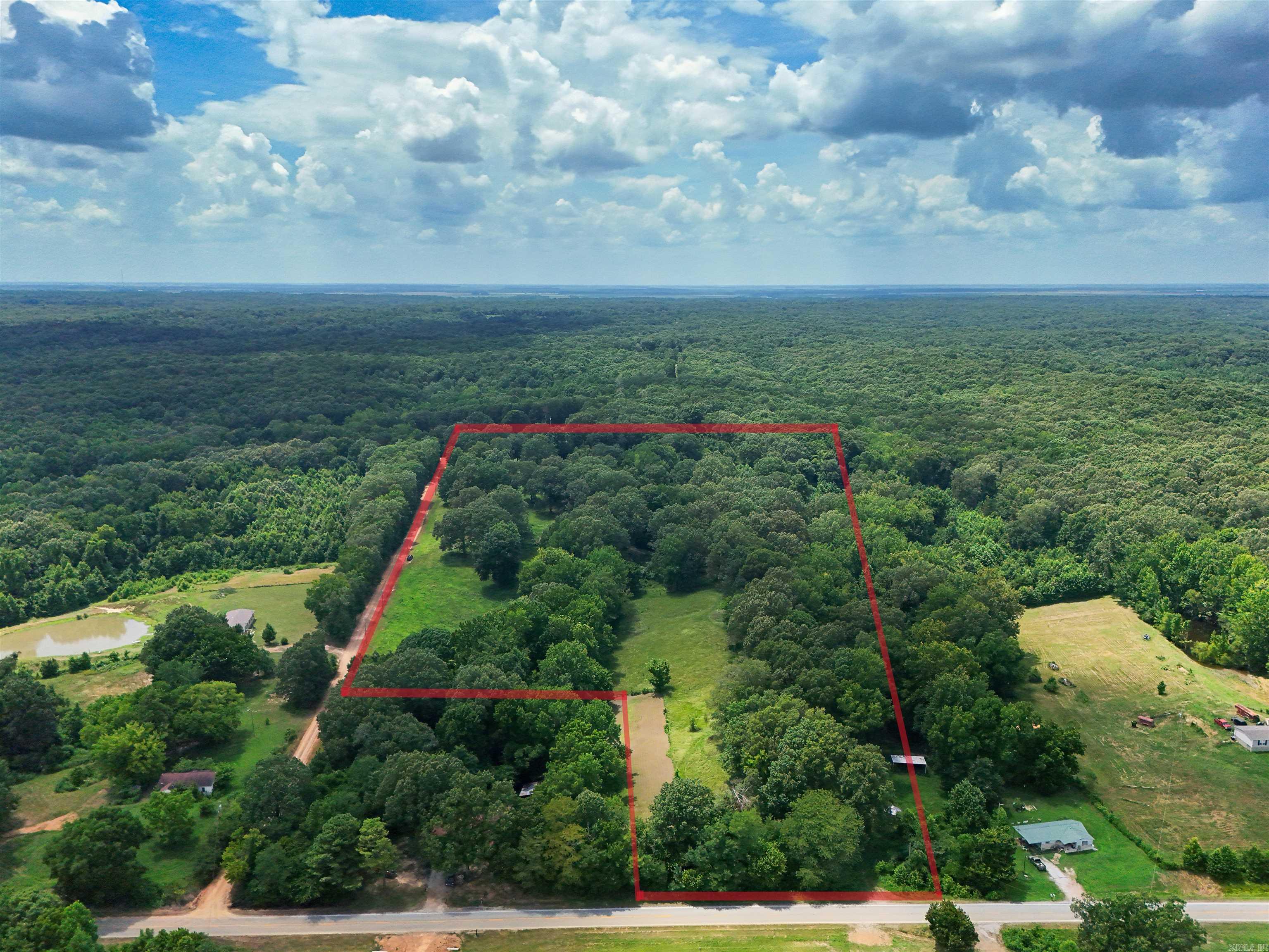 Welcome to the market a perfect piece of property to build a dream home on. Located on Crowley's Ridge just north of Bay Village and South of Harrisburg on Hwy 163, this property is 14.8+/- acres of timber and rolling pasture land. No matter what your preference is on how you want your house to sit, this property offers multiple places to start construction with MINIMAL work needed to the land. You will not have to do extensive tree removal or dirt work for your home project. The best part of it all is that you have frontage on both HWY 163 an Mink Road. So, if you do not want your home to be on a Highway, build your driveway off of the county road on the south side. If you want a driveway on the main road, that option is yours as well. The property offers seclusion as well as ease of access. There are 100 year old oak trees that can offer a stunning view out of any window of your home. Don't miss out on your chance to own Crowley's Ridge acreage.