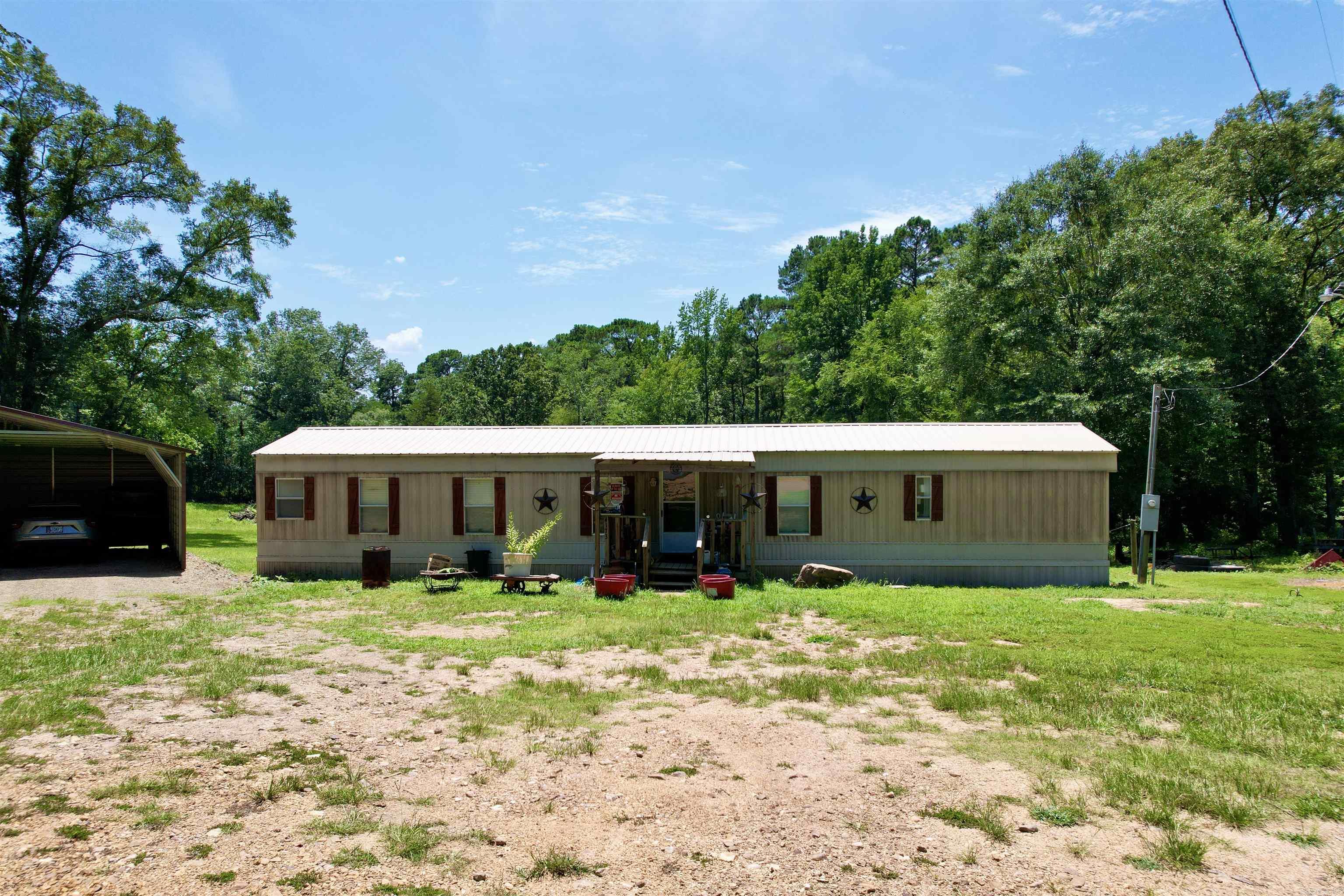 Welcome to peaceful country living at 4173 Midway Rd! This well-maintained 2 bedroom, 2 bath mobile home sits on a scenic 3.64-acre lot, offering privacy, nature, and convenience. Inside, youāll find a spacious master suite with a garden tub, and the home has seen many updates in recent yearsāincluding a new metal roof installed in December 2024, a new septic system, updated water lines, and underpinning all within the last four years. A 30x30 carport, added less than a year ago, provides ample covered parking, and thereās additional outside storage space for your tools or hobbies. A charming wet weather creek flows just below the homeāperfect for enjoying quiet mornings while watching the wildlife. All appliances convey, including washer and dryer. Located less than 5 miles from Ouachita School, this property combines comfort, charm, and country life with convenience. Donāt miss your chance to make this peaceful retreat your own!