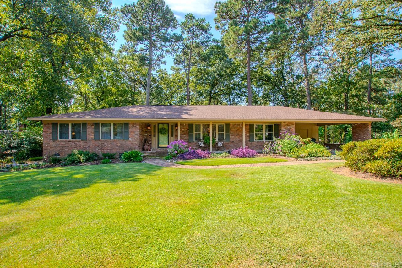 If you're looking for 1960's style home and the charm of an older home, come take a look. 3 large bedrooms, 2 full baths with updates. Large open Living Room with Dining, Den Family room with woodburning fireplace. Original hardwood flooring, freshly painted interior, Kitchen remodel with stainless steel appliances and granite counter tops. Laundry room is spacious with a wall of cabinets for pantry use and storage, plus a storage room off carport that is heated/cooled. Two patios surrounded by landscaped flower beds. Roof 2019, Water heater 2024, Storm Cellar, New double gate 2025, and room to garden to your hearts content.