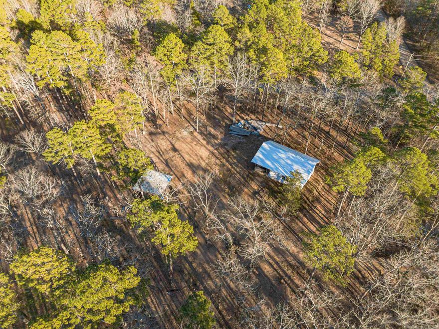 Tucked away on 5 acres just a few miles from the town of Bigelow, this property offers the perfect blend of natural beauty and future potential. Featuring a partially finished new construction home with utilities, tons of lumber, and additional building supplies included- giving you a major head start and financial savings while allowing you to customize your own personal finishes. The mature hardwoods, open space, and beautiful blue water creek that spans the length of the acreage creates a peaceful backdrop that feels private and scenic. Additionally, there's a covered awning for parking, and an RV hookup (also with septic) beside the home, making it ideal to live on site while completing construction or hosting guests in the future. If you're looking to build your dream home or weekend getaway with NO restrictions in an absolutely beautiful location it doesn't get any better than this!