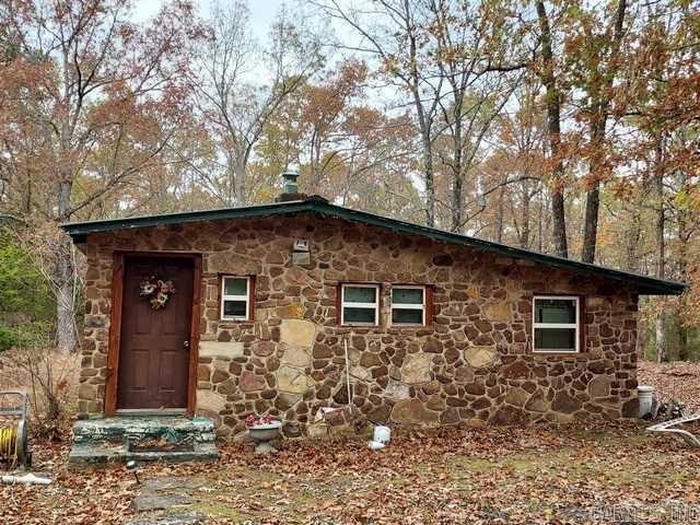 If you are looking for an affordable property, here is 10+ acres with a fixer upper stone cottage, rural water, elect., and septic all there. Get your hammer and nails and make it your.