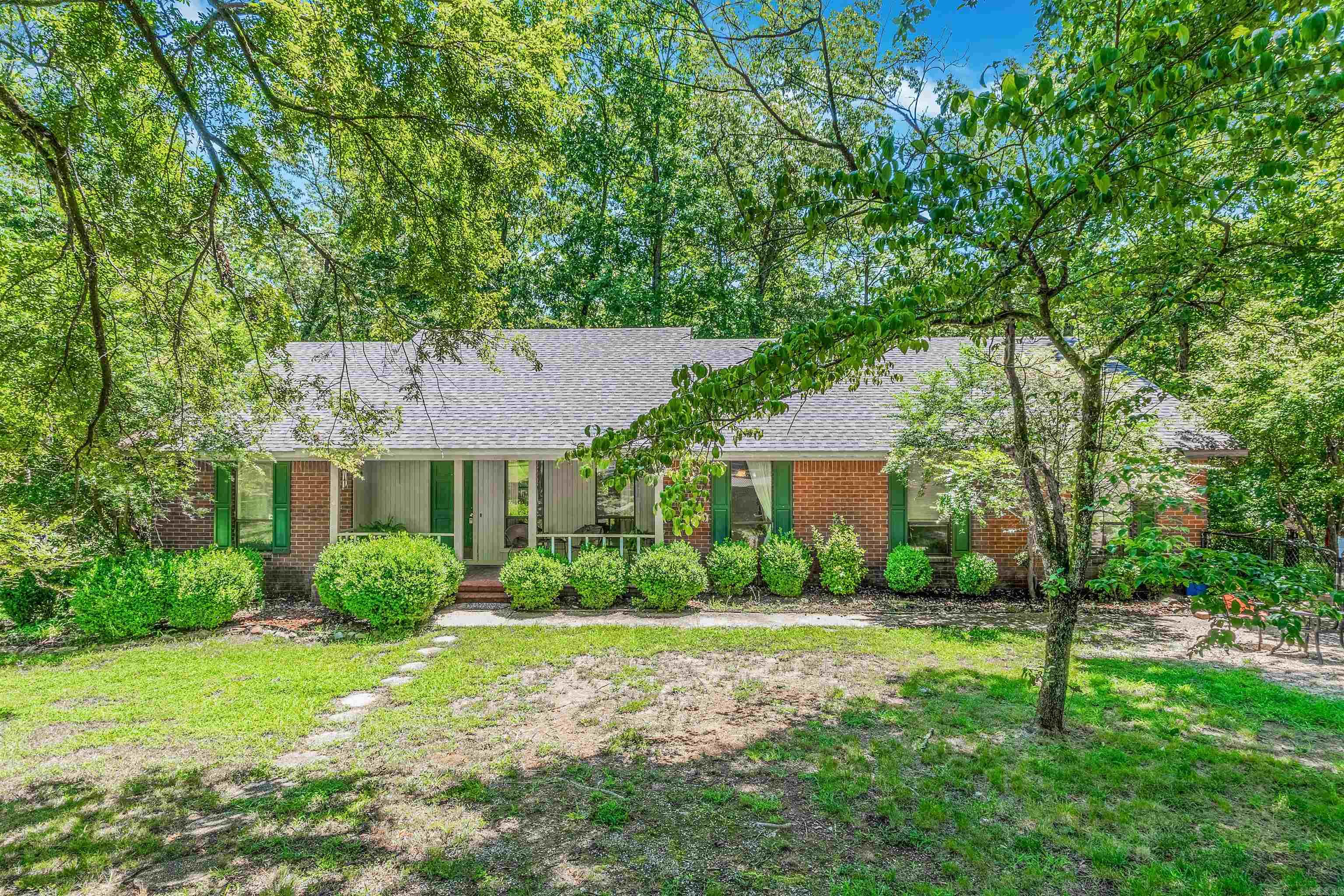 Nestled on over 2 secluded acres near the lake, this charming 3-bedroom, 2-bath home offers the perfect blend of comfort and privacy. Tucked away at the end of a quiet cul-de-sac, the setting provides unmatched peace and minimal traffic. Step inside to find warm, updated flooring throughout and a cozy living room with a classic fireplace and new patio doors that open to a peaceful outdoor retreat. The spacious kitchen boasts tile countertops, a new stainless steel refrigerator, and an inviting dining area ideal for gatherings. The thoughtfully designed split floor plan features a private primary suite with an ensuite bathroom, separate from the two guest bedroomsāperfect for added comfort and quiet. Outside, enjoy the quiet wooded surroundings and plenty of room to roam or garden. Whether you're looking for a weekend getaway or your forever home, this lakeside haven offers a unique escape just minutes from the water. Agents see Remarks*