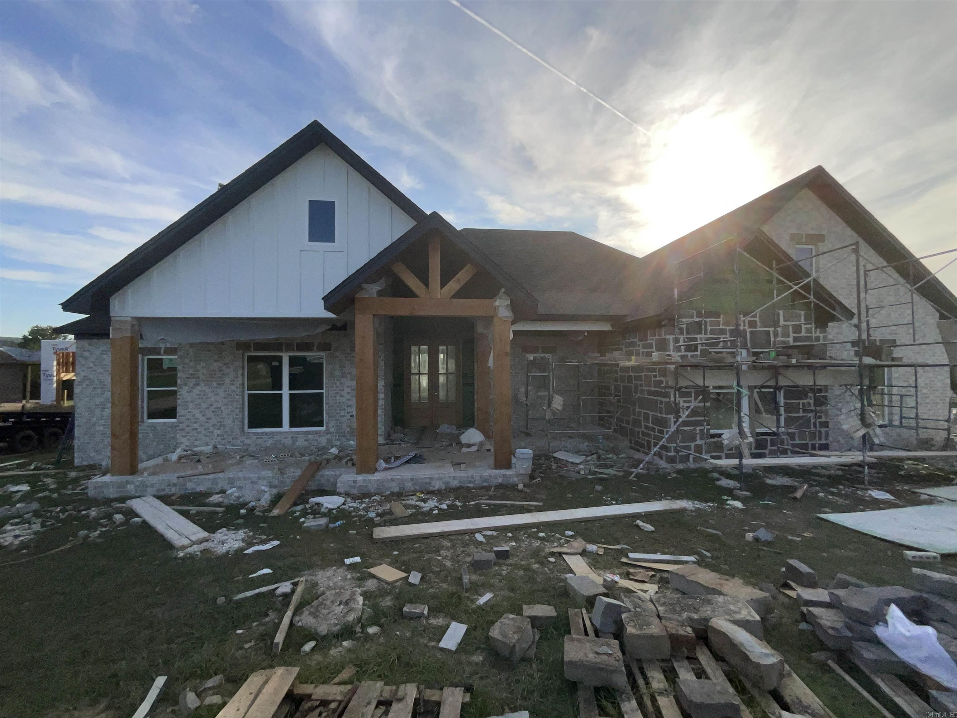 Lakefront lot with stunning water views! Beautiful lakefront property features vaulted Ceilings in the living room that extend to covered patio. The vaulted windows flood the open concept plan with Natural light. The spacious back porch is perfect for relaxing or entertaining while overlooking the water This home offers four generously sized bedrooms and three full bathrooms providing plenty of space for family and guests. The kitchen is a chef's dream with a fabulous pantry abundant cabinetry and plenty of room for meal prep and storage. The primary suite includes a huge walk in closet for all your wardrobe needs. A three car garage offers ample storage for all your lake toys and more. Whether you're looking for a weekend retreat or a year round residence this home has it all!