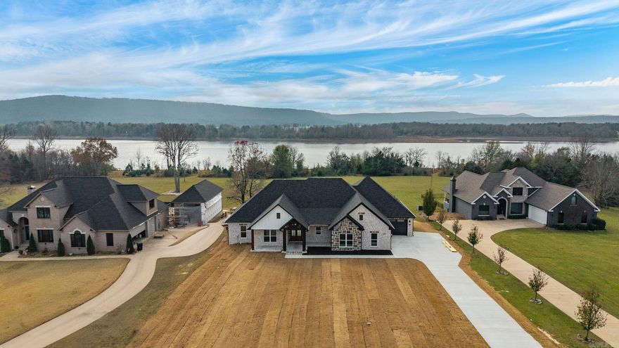 Lakefront lot with stunning water views! Beautiful lakefront property features vaulted Ceilings in the living room that extend to covered patio. The vaulted windows flood the open concept plan with Natural light. The spacious back porch is perfect for relaxing or entertaining while overlooking the water This home offers four generously sized bedrooms and three full bathrooms providing plenty of space for family and guests. The kitchen is a chef's dream with a fabulous pantry abundant cabinetry and plenty of room for meal prep and storage. The primary suite includes a huge walk in closet for all your wardrobe needs. A three car garage offers ample storage for all your lake toys and more. Whether you're looking for a weekend retreat or a year round residence this home has it all!