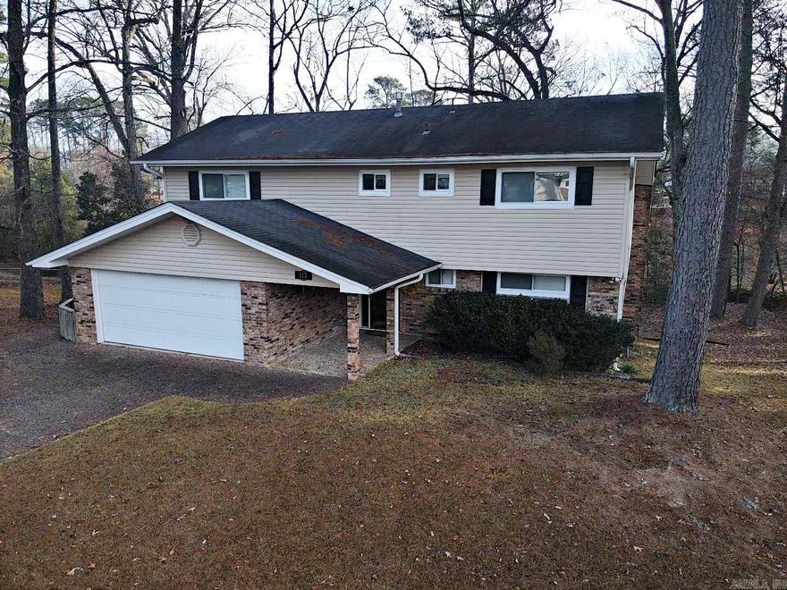 This custom, craftsman style 4-bedroom, 4 bath home sits on 2 beautiful lots in a well-desired sub-division.  It features a tri-level layout with a fully functional walkout basement apartment. It has two gas fireplaces, a vaulted living room/dining room ceiling several built in cabinets/desks and lots of storage. Updates include new windows, new roof and HVAC in 2024, and a new hot water heater.  Extra insulation installed making for very inexpensive utilities. The large deck has a spectacular view of nature. Sitting minutes from the I-30 corridor and easy access to surrounding towns and shopping, this a must see for home shoppers needing large square footage. Schedule an appointment today!