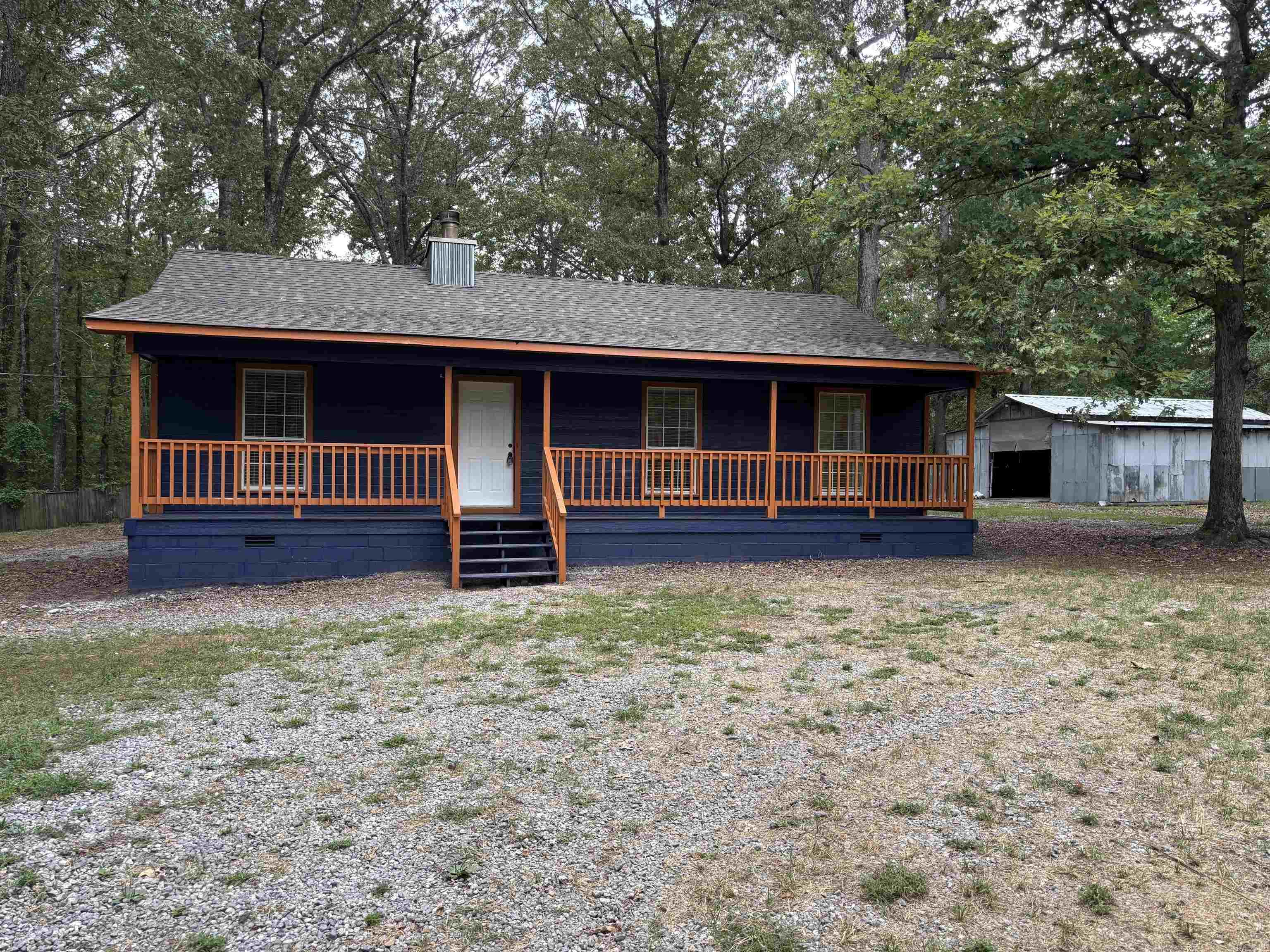 Imagine getting to choose between sitting on your front or back covered porches in a serene peaceful country setting! This newly updated home which sits on on 1.26 peaceful acres in Saline County with mature trees could be your perfect paradise! Features include three bedrooms, two freshly remodeled bathrooms, a large living room with a vaulted ceiling and an updated kitchen featuring new stainless steel appliances, tile floors and granite countertops! The oversized laundry room and panty is just a bonus after all of that. This property also includes a very close pole barn style shop for the handyman/mechanic who may need it. Brand new HVAC and brand new roof were just installed.