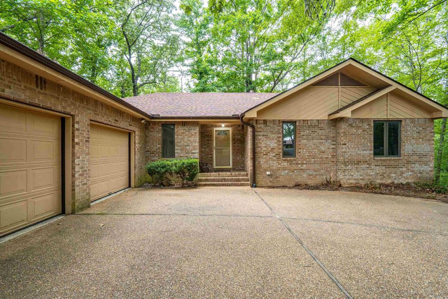 Woodland all brick beauty nestled with a peaceful nature surrounding. This home is a rare find, combining the charm of a 2.2 acre secluded setting with well-designed interior spaces with timeless appeal with lots of special features such as vaulted ceilings and built ins.   The main floor consists of a master bedroom and a second bedroom, abundant storage & generous closet space and storage solutions throughout the home. Downstairs has a huge den and two bedrooms, bonus room and a huge storage room!  THREE car garage and so much more   Large covered area for RV or boat.