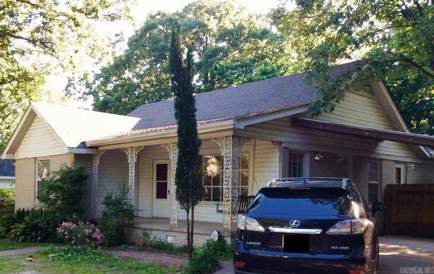 Watch the world go by from red porch swing! Brick 1-level. Decorative fireplace in living room. Separate dining. Hardwoods & tile thru-out. Eat-in Kitchen w/gas range, fridge, dishwasher & disposal. Laundry closet in hall. Tub/shower combo in 1 bath, stand up shower in 2nd. 1 car carport. Fenced & private. Storage Room. Walk to Sip & Shop in Hillcrest & restaurants. Razorback Game parking. NO PETS! NO SMOKING! Tenant pays utilities & is responsible for yard upkeep. Rock fire-pit/grill. Seller is Realtor.