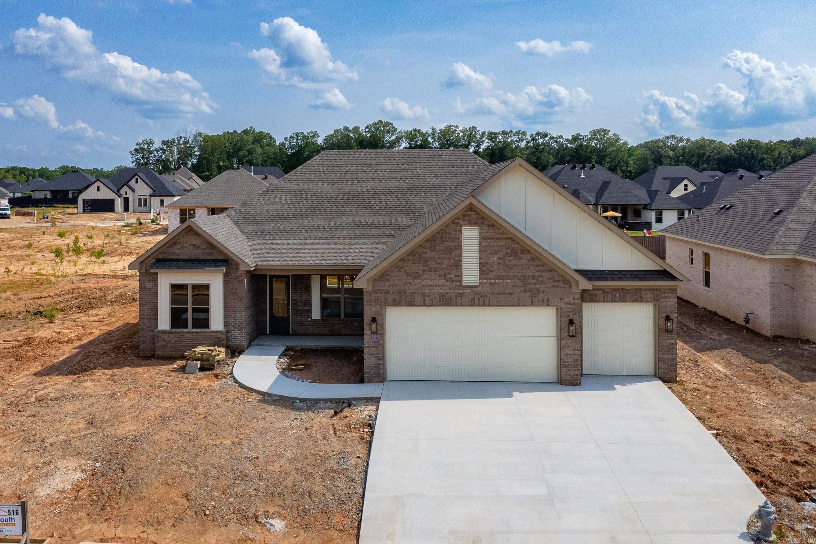 Beautiful ALL BRICK, NEW CONSTRUCTION home is one level on level lot in Country Club of Arkansas Subdivision. Covered front porch makes for a grand entrance into foyer. Large formal dining room w/ beams. Spacious living area w/ stone to the ceiling fireplace/electric logs and beams in the ceiling. Living area opens to gourmet chef's kitchen w/Quartz countertops, island and breakfast bar, stainless steel appliances, convection oven, & pantry. Primary suite is fit for royalty. You immediately fall in love with the primary spa bath where you can wash all your cares away; double sink vanities, spa soaking tub and large custom tiled shower. The primary walk-in closet is massive w/built-ins. Separate laundry room leads to primary closet and locker area. 3 more guest rooms and full bath is located on the other side of the home. Half bath/powder room for your guests off kitchen. Relax on your covered patio after a long day or enjoy entertaining family & friends! The 3 car garage is a bonus to this amazing home. Stairs leading to the attic for tons of storage. Make it your home today!