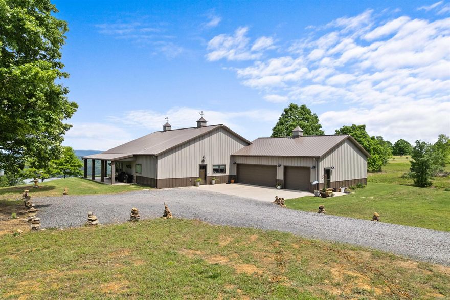 Experience Lake living at it's finest on beautiful Greers Ferry Lake with this stunning 3-Bedroom, 2-Bath Custom home that blends modern designed with rustic charm.  Inside you'll be captivated by soaring vaulted ceilings with exposed beams, creating a dramatic yet inviting open-concept living space. The designer kitchen is a true showstopper--featuring custom cabinetry, sleek countertops, high-end stainless appliances and more.  Natural light pours in, highlighting the home's clean lines and upscale finished throughout.  The living and dining areas flow seamlessly, offering both comfort and functionality, all while framing peaceful views of the surrounding landscape and lake beyond.  Step outside to a spacious covered porch adorned with string lighting--an ideal setting for relaxing evenings, hosting guests, or enjoying quiet mornings overlooking the lake.  A separate approximately 750 sq foot heated and cooled studio provides versatility--perfect for a guest suite, income producing rental, private office, or creative space.  15 min to Ferguson's Choctaw Marina 40 min to ATV Trails